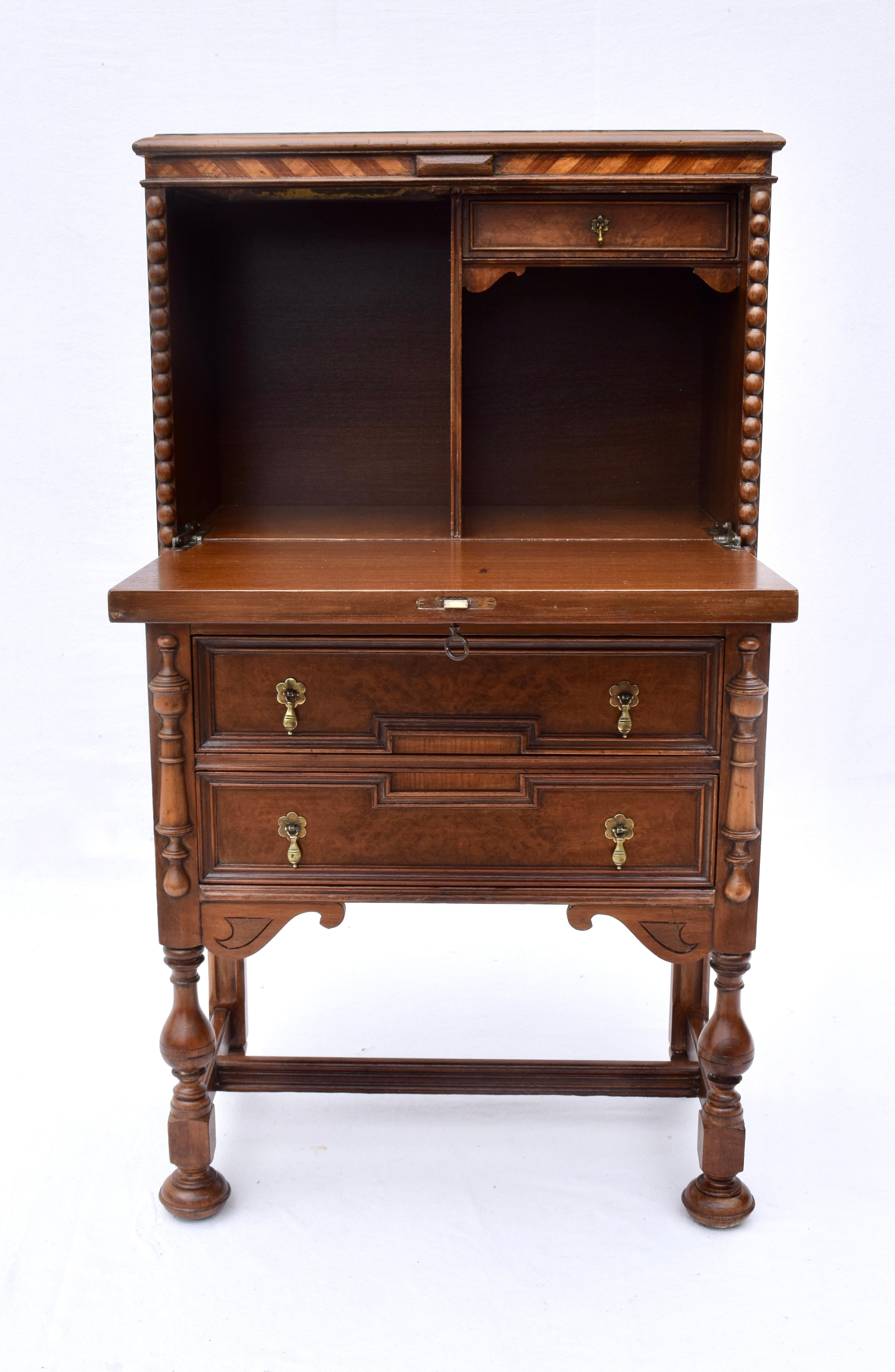 An early 20th C. Jacobean style bar cabinet with drop down front & three drawers.
Lovingly restored, our refinishers removed 4 layers of paint to surprisingly expose burl & other woods in addition to intricate inlay designs. A multifunctional,