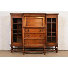 Antique English Jacobean Carved Oak Glass Front Double Bookcase, Circa 1920s