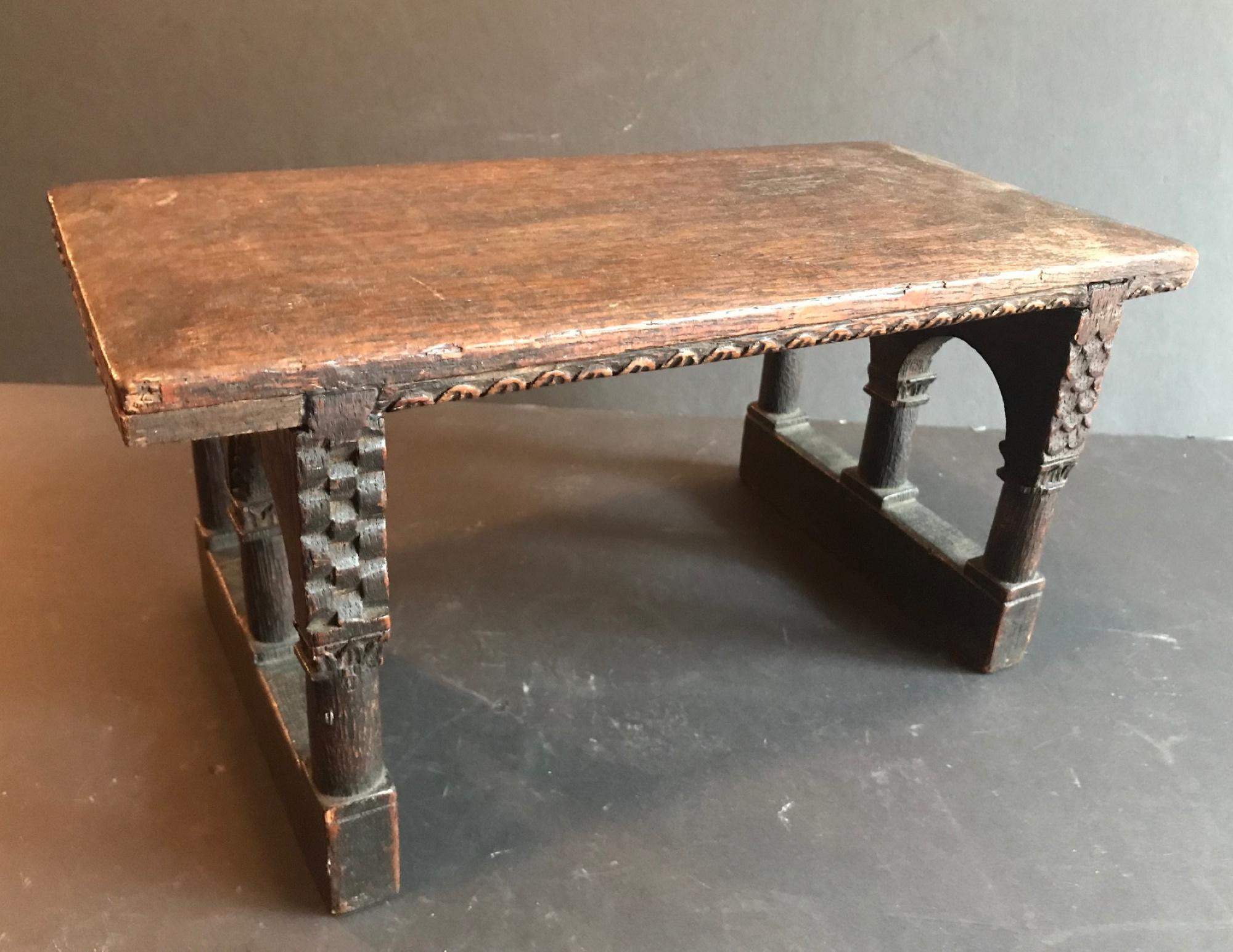 This is a very unusual small footstool or bench. Beautiful chip-carved decoration make this little furniture special. Made out of English Oak, patina and proportion on this miniature are perfect.
Very good condition. Wear due to age and