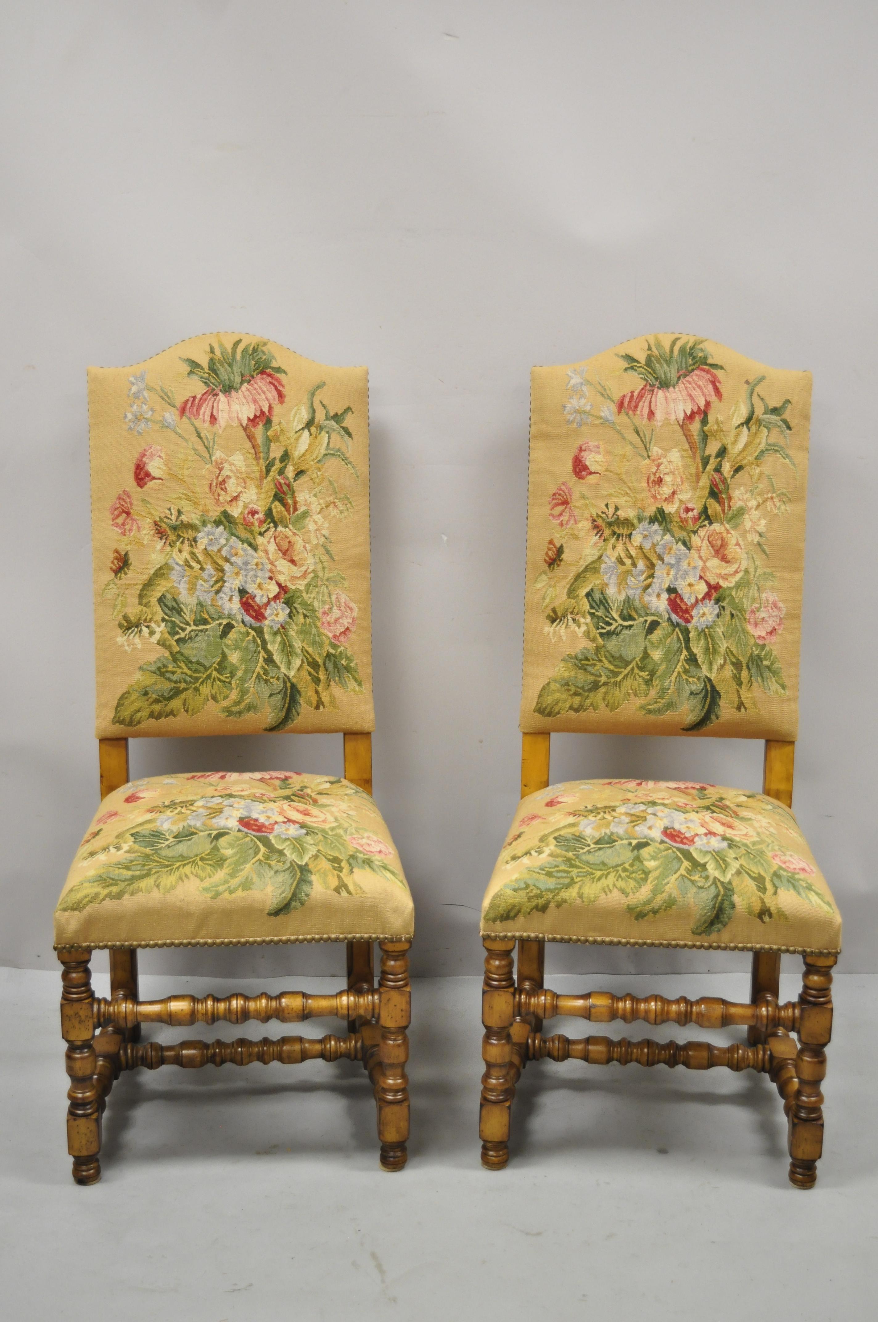 Antique English Jacobean Floral Needlepoint tall back dining side chairs - a pair. Item features floral needlepoint backs and seats, turn carved legs and stretchers, solid wood frames, beautiful wood grain, distressed finish, very nice antique pair,
