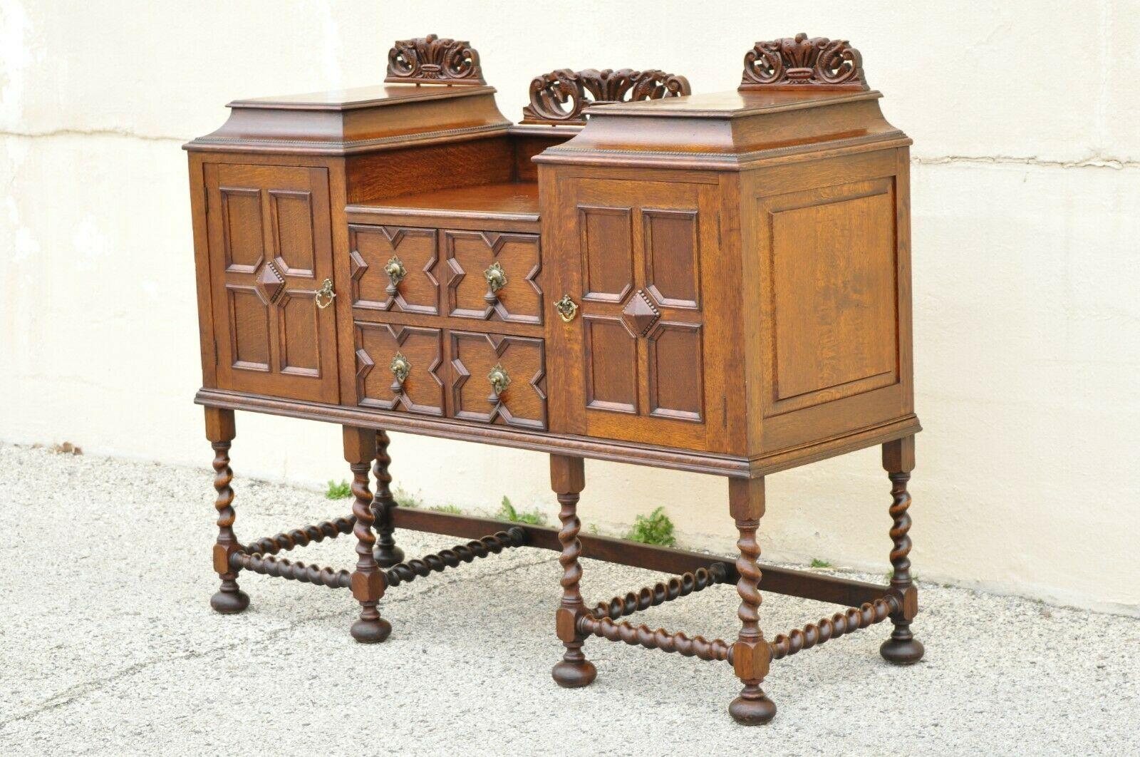 Antique English Jacobean Renaissance spiral Barley Twist oak sideboard buffet. Item features spiral barley twist legs and stretcher base, 2 drawers, 2 swing doors, beautiful wood grain, 3 carved backsplashes, very nice antique item, quality English