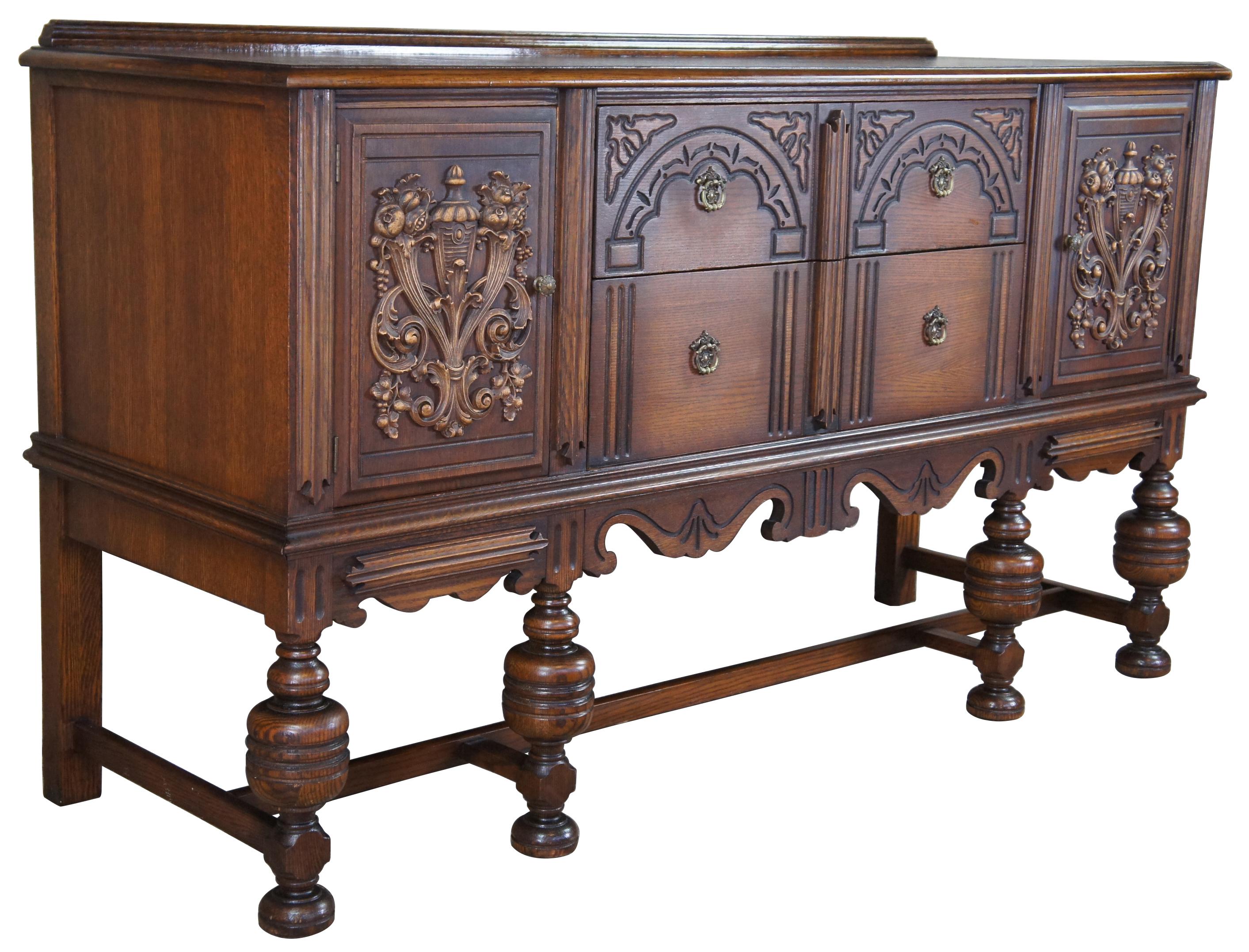 Early 20th century Jacobean / Elizabethan revival buffet or server by Basic Furniture Company out of Waynesboro, Virginia. Made from oak with two drawers between two cabinets supported over carved serpentine apron over turned baluster supports and