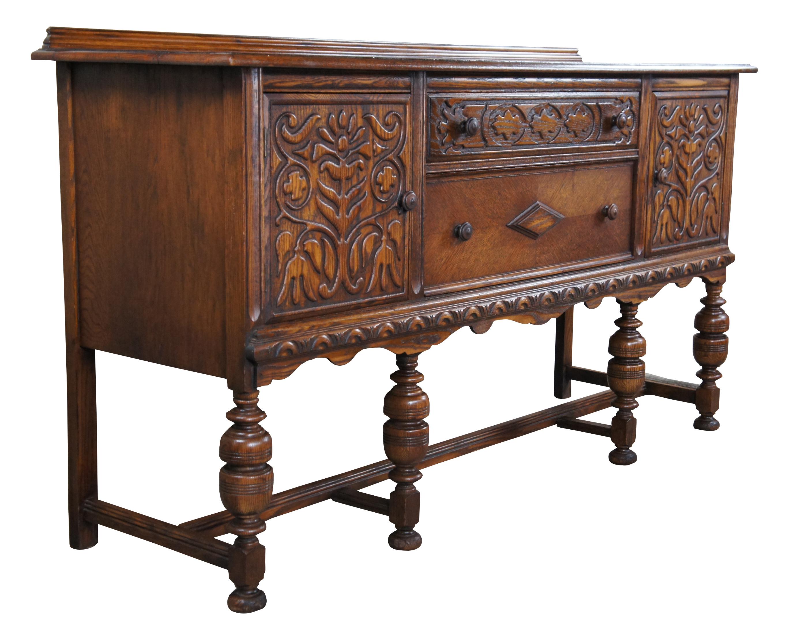 Early 20th century Jacobean / Elizabethan revival buffet or server. A rectangular form made from oak two central drawers flanked by outer storage cabinets. Features beautiful carving throughout, a serpentine apron, sleek backsplash and turned