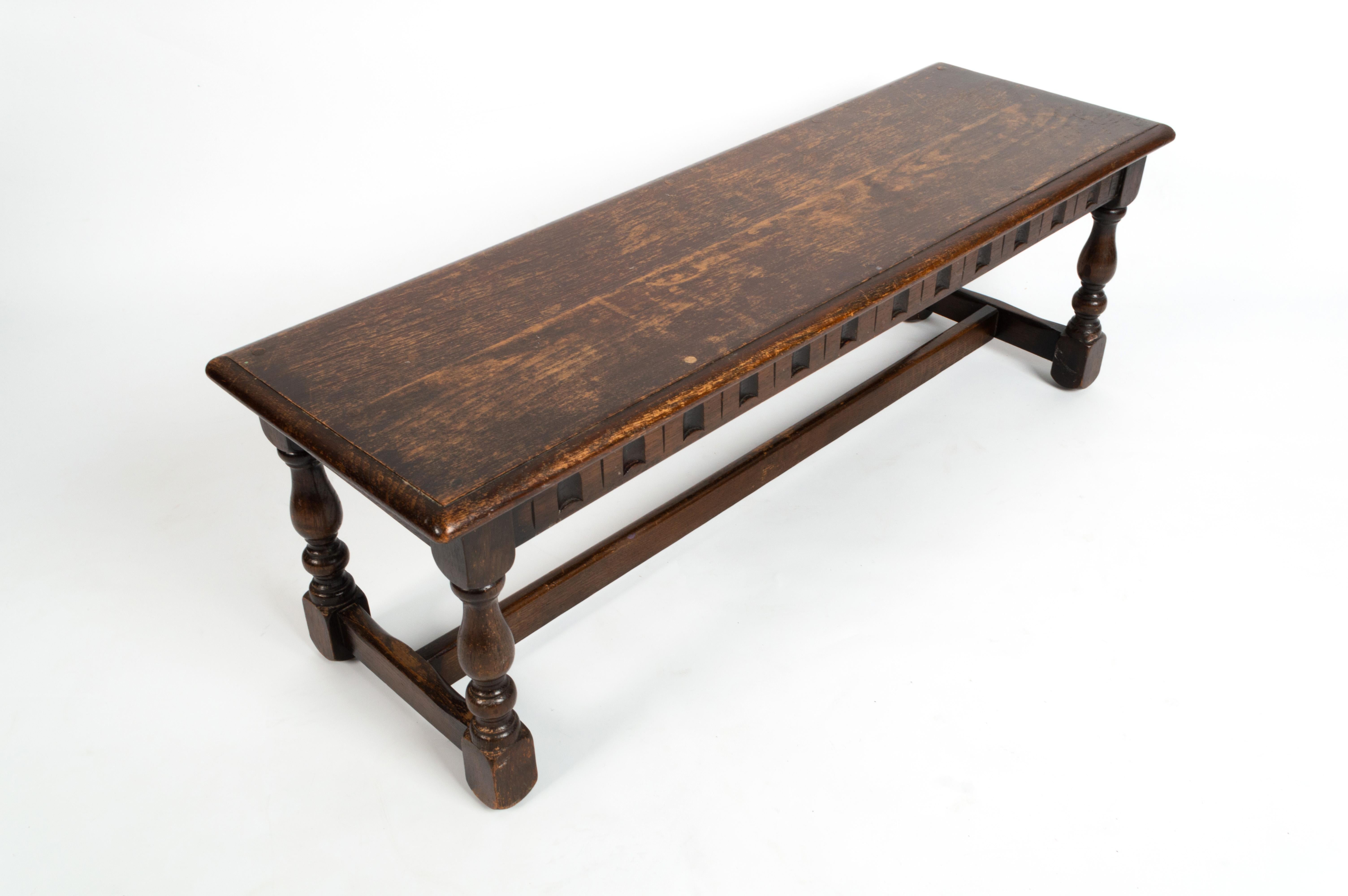 Antique English Jacobean style carved oak joint bench stool
circa 1920

A good size piece. Of good solid construction. Expected signs of wear to plank top, commensurate of age, old repair to one bevelled edge (please refer to photos).

