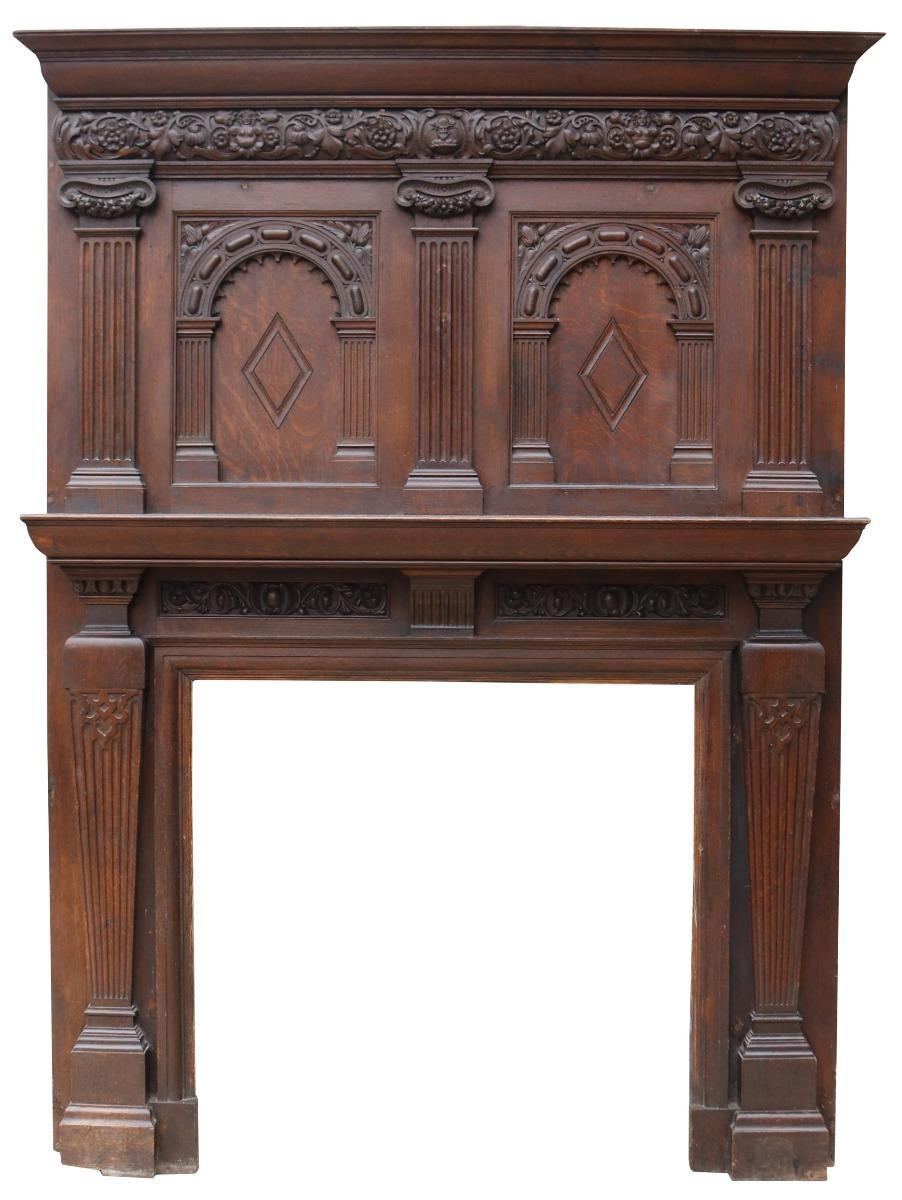 A tall antique Jacobean style carved oak fireplace with overmantel reclaimed from a manor house in Suffolk. Impressive in style and stature, this fireplace dates from the late 19th century but encompasses earlier Tudor and Jacobean styles. Today, it
