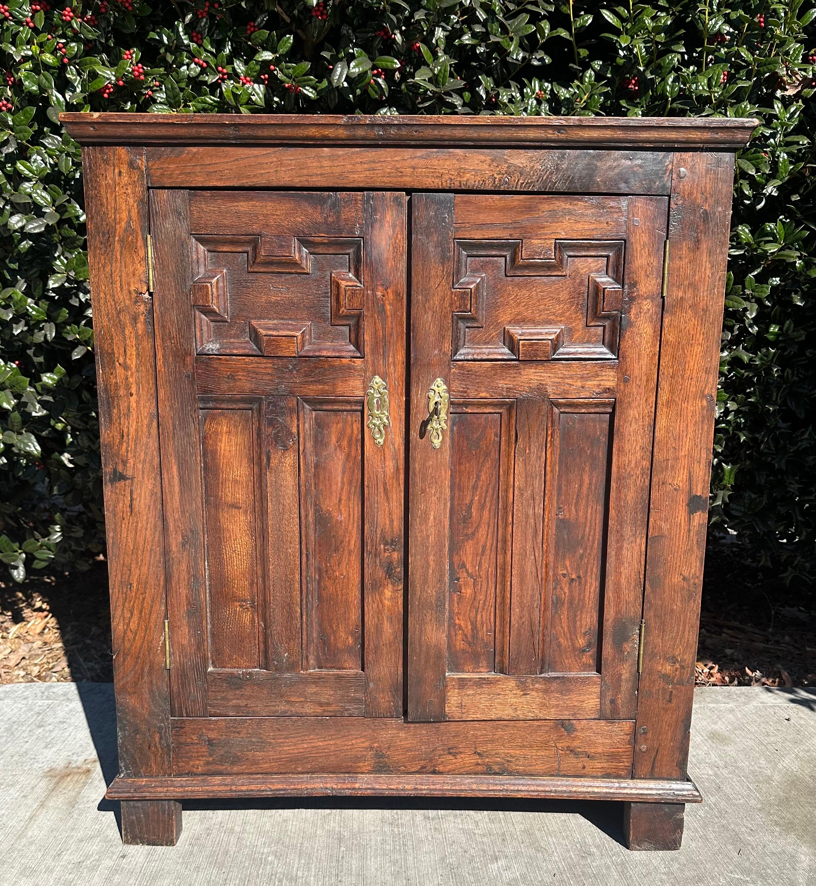 Antique English  Jam Cabinet/cupboard 18th century hand carved oak with brass.

This petite 12 inch deep cabinet would be perfect in a hallway, bath, or small nook that needs an accent piece with storage. It also would make a perfect mini bourbon