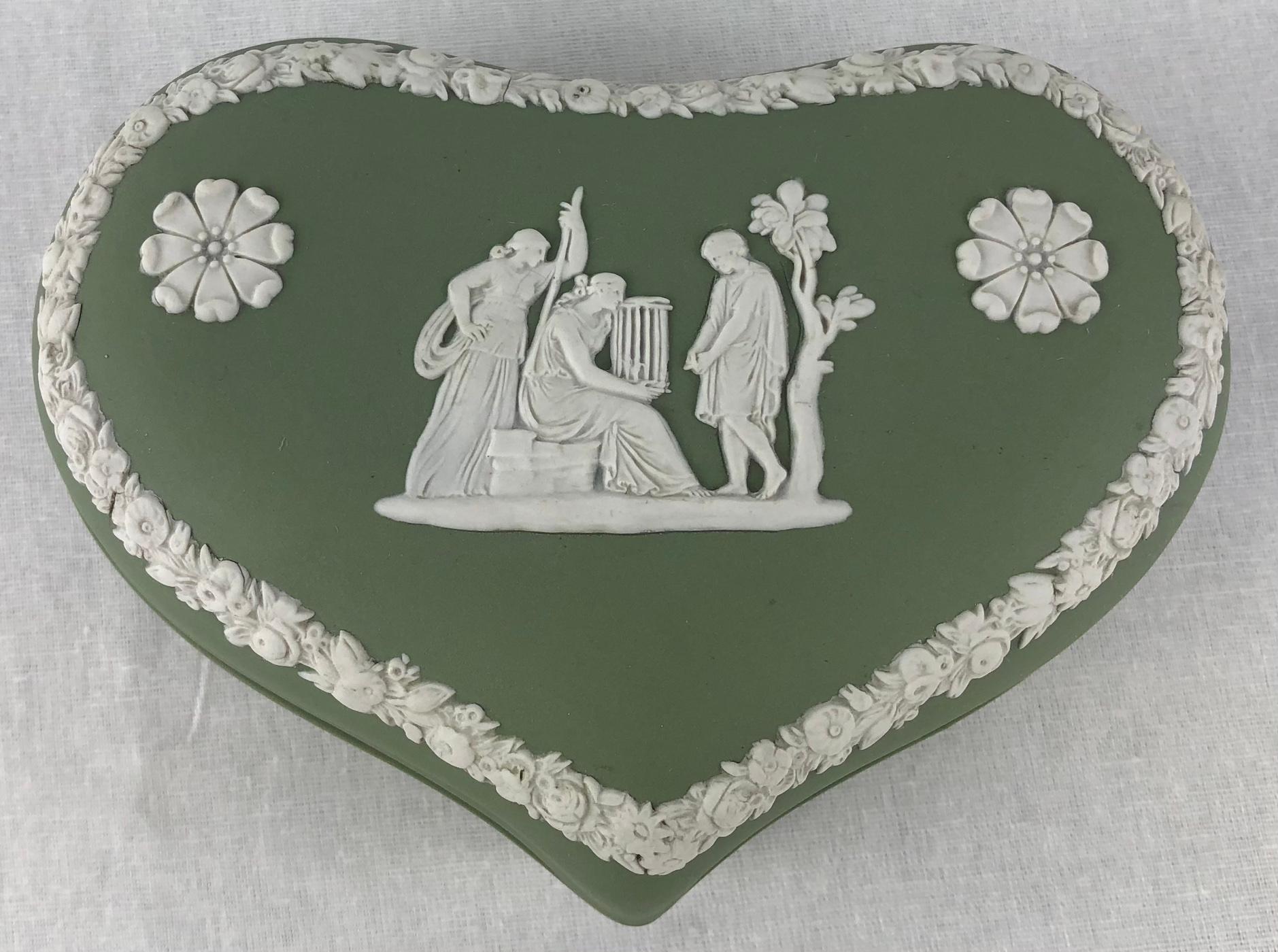 Beautiful English Wedgwood Jasperware covered jewelry or trinket box in “Wedgwood Green” features a repeating motif of white, high relief acanthus leaves alternating with floral sprigs and a beautiful scene.

Jasperware or Jasper ware is a type of