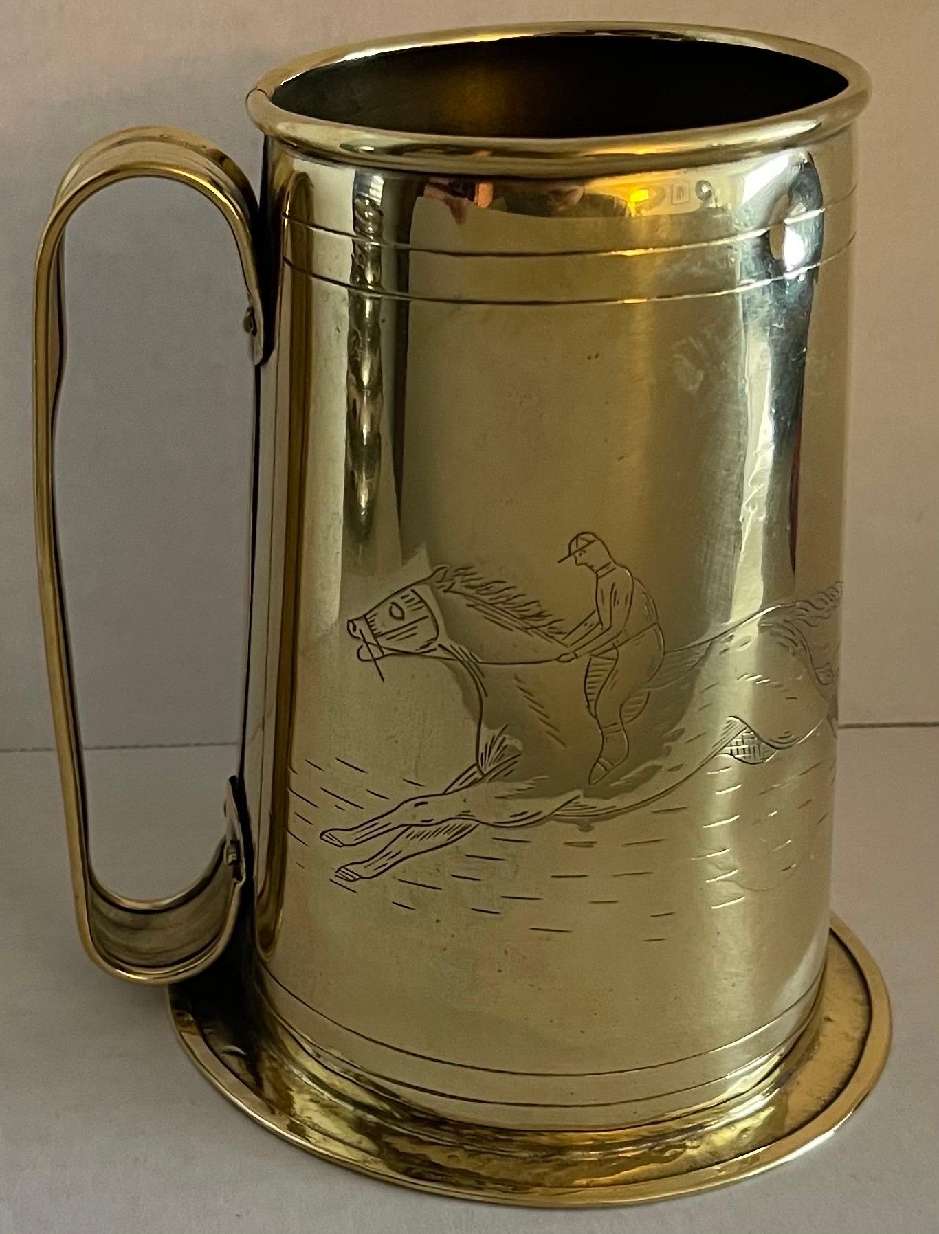 Antique 1930s English large brass tankard. Etched equestrian horse and rider and “Ye Olde Horse & Jockey Suppy”. 
Newly professionally polished to a high shine. Unlacqured brass will develop a patina over time. Hammered detailing around the base.