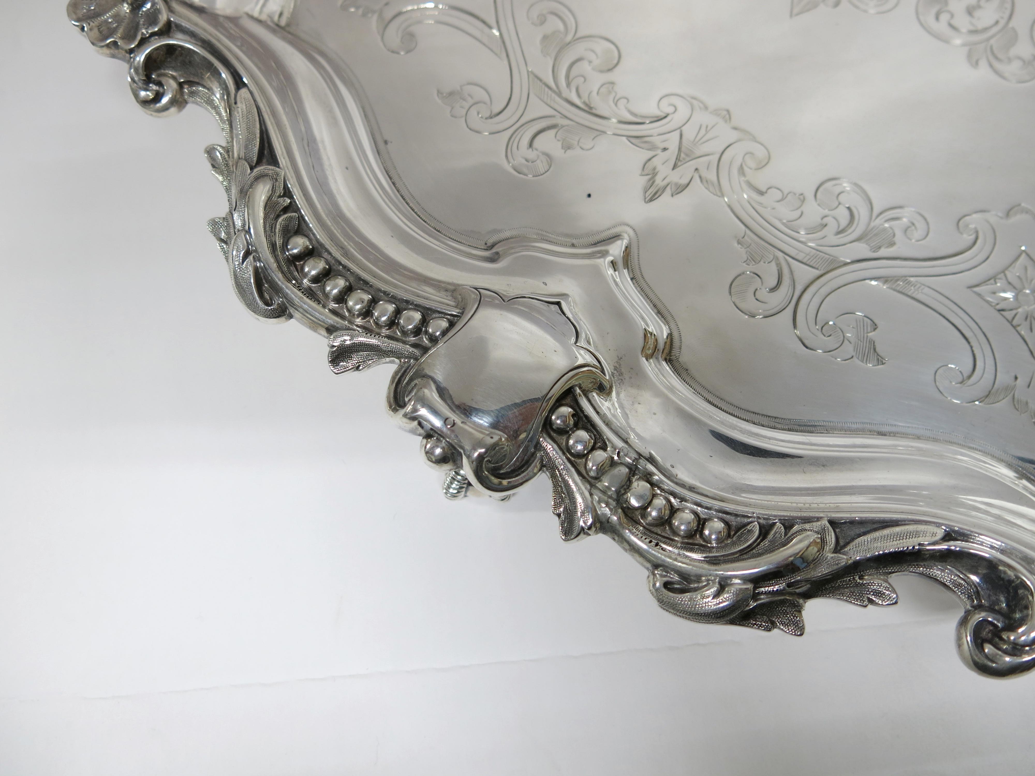 Large round footed, sterling silver tray. Made by Martin & Hall, Victorian, English, dated 1875. The tray stands on 3 ball and claw feet. Hallmarked to underside of tray.
Measures: 20