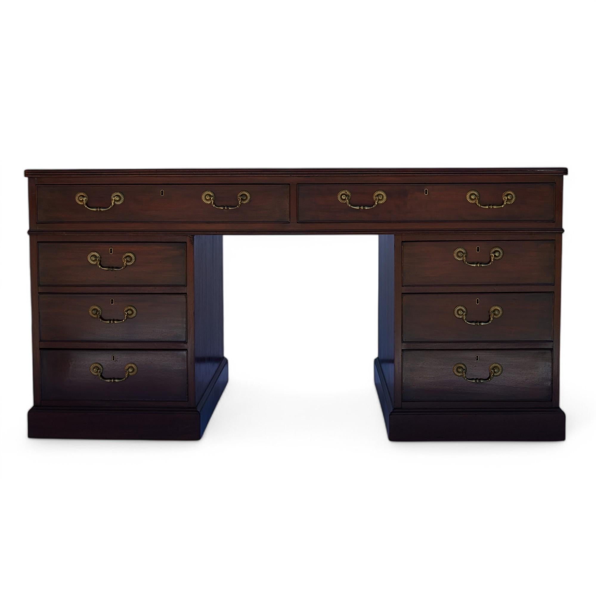 Impressive late 18th or early 19th Century  English Georgian partners desk handcrafted in mahogany featuring the original tooled leather top over a case with two drawers on the upper section and 3 drawers per pedestal, identical arrangement on both