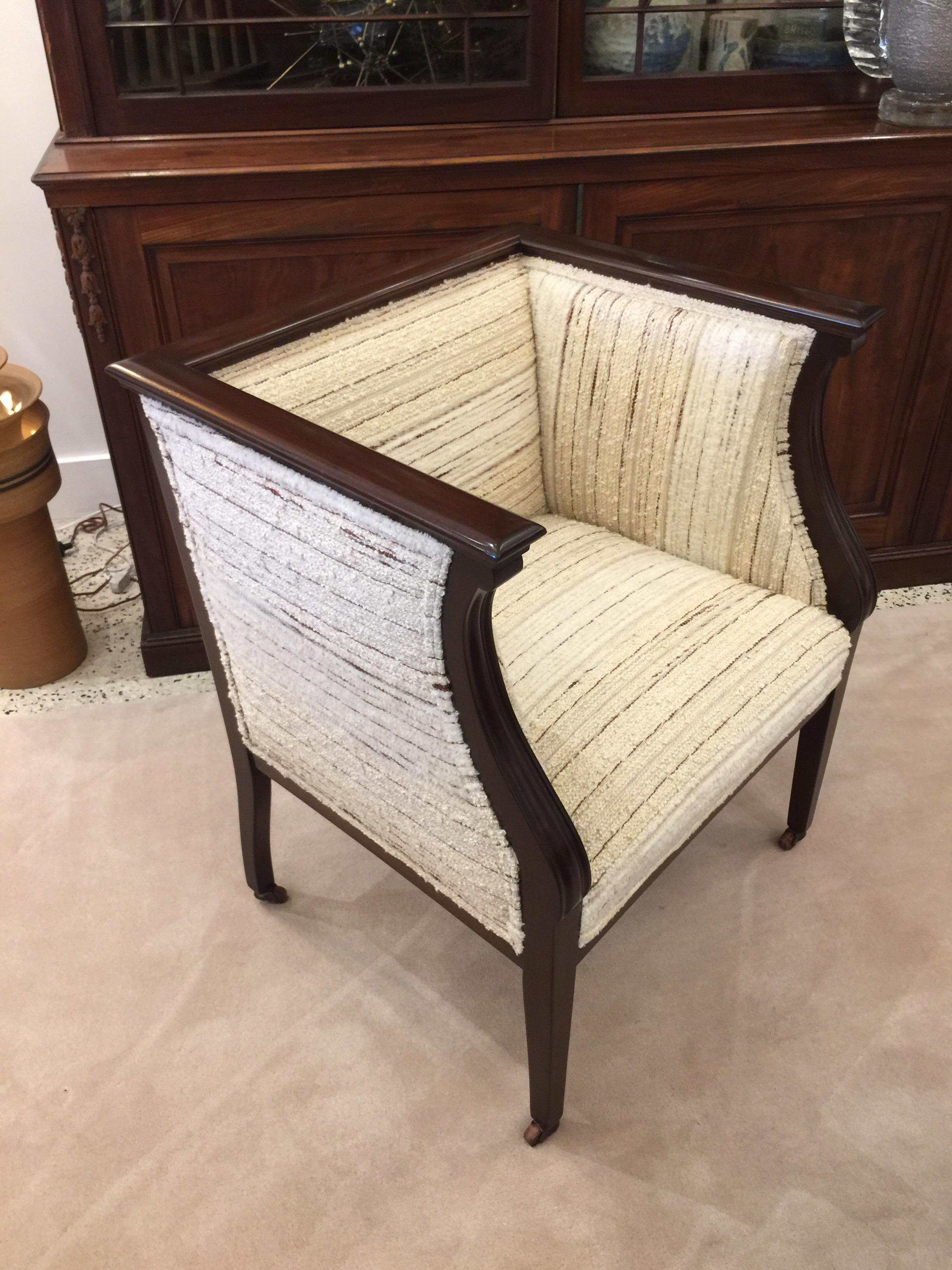 Very important and heavy mahogany framed chair with high back and beautiful nubby wool upholstery.