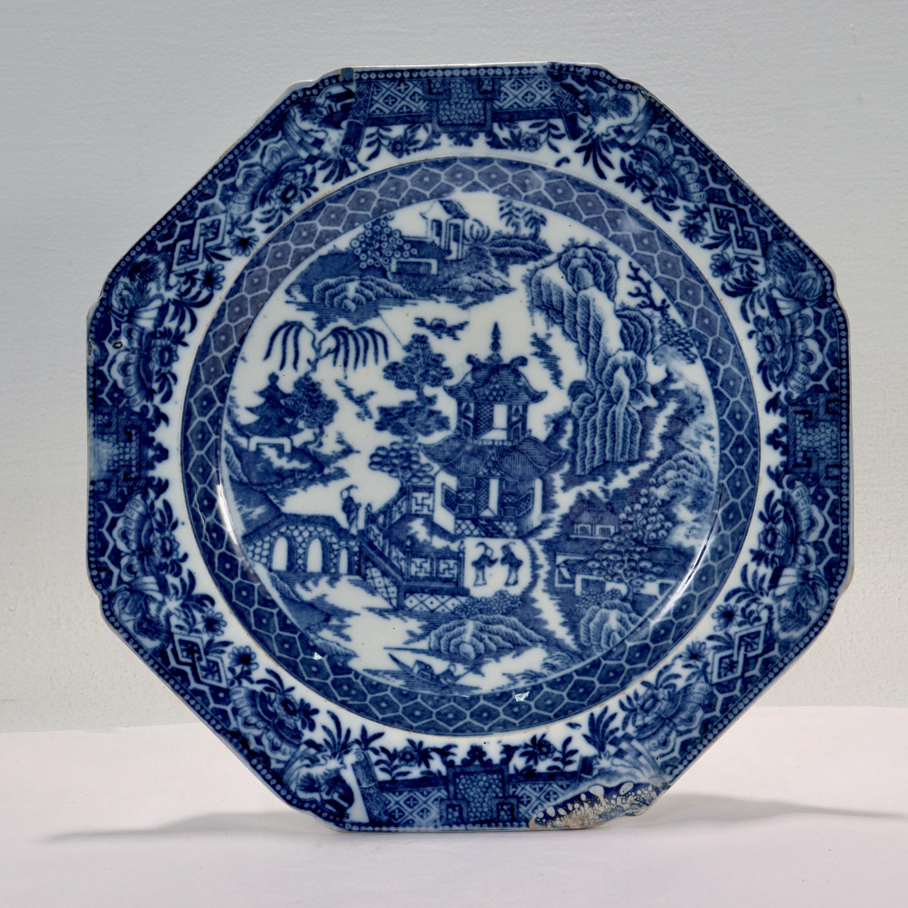 A fine antique English soft paste porcelain or creamware plate.

With a blue willow underglaze blue transfer decoration. 

Attributed to Longport. 

Marked to the reverse with a blue underglaze flower mark.

Simply a wonderful piece of early English