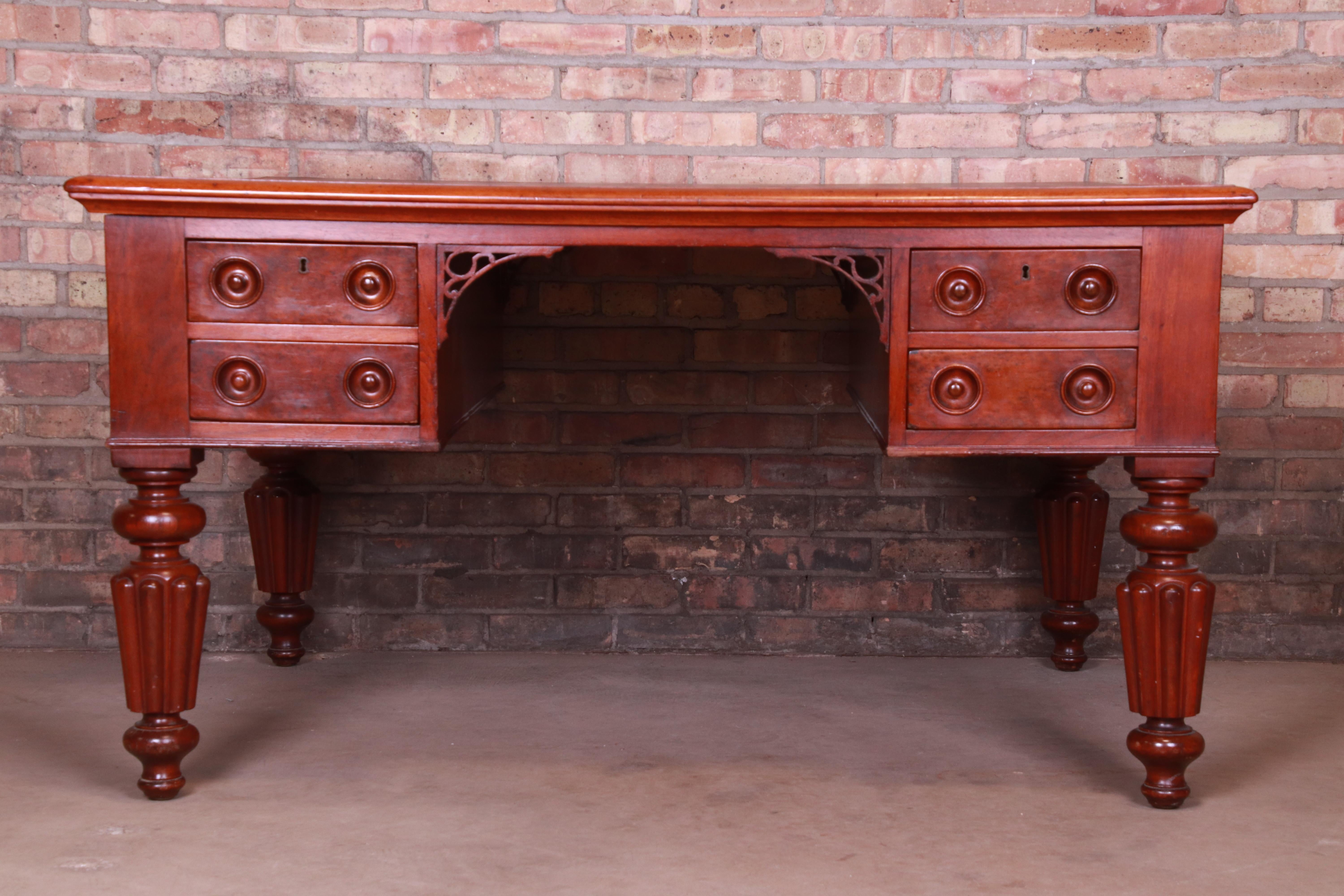 An exceptional antique English leather top executive partner desk

England, circa 1850

Mahogany, with burl wood drawer fronts and leather top.

Measures: 56.13