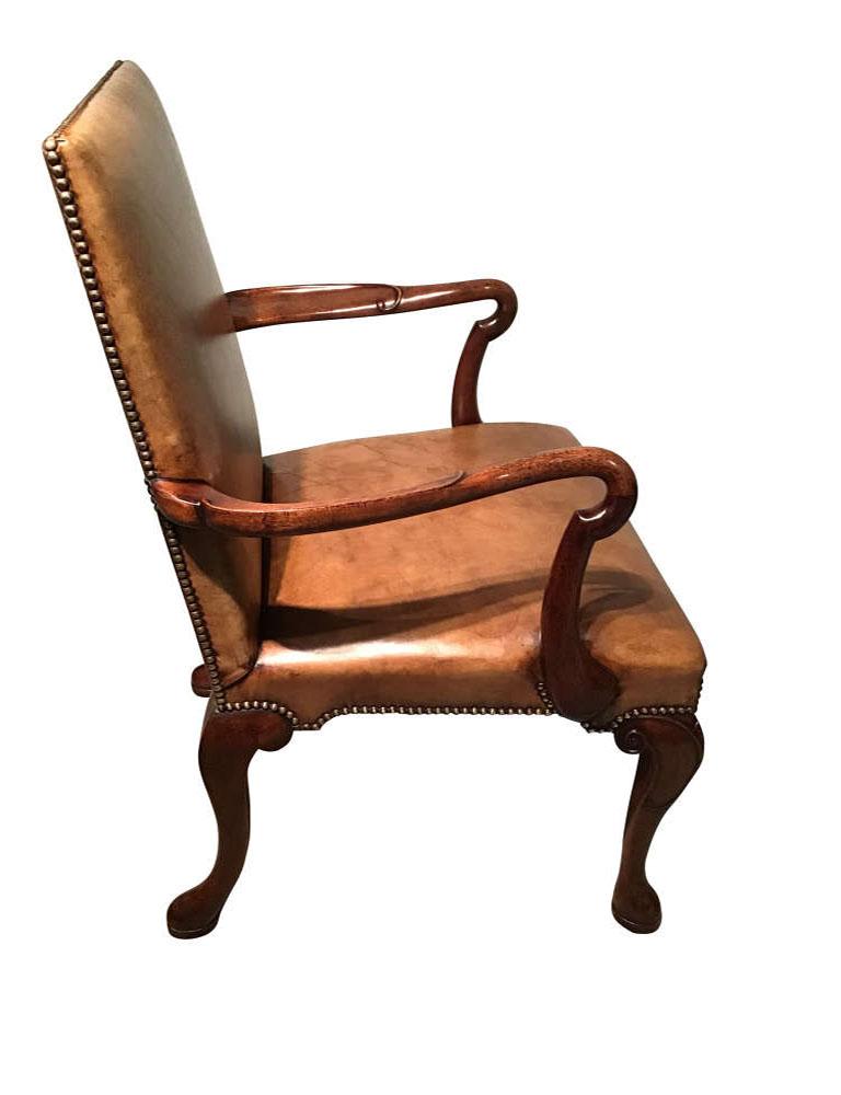 Antique English mahogany and leather armchair.