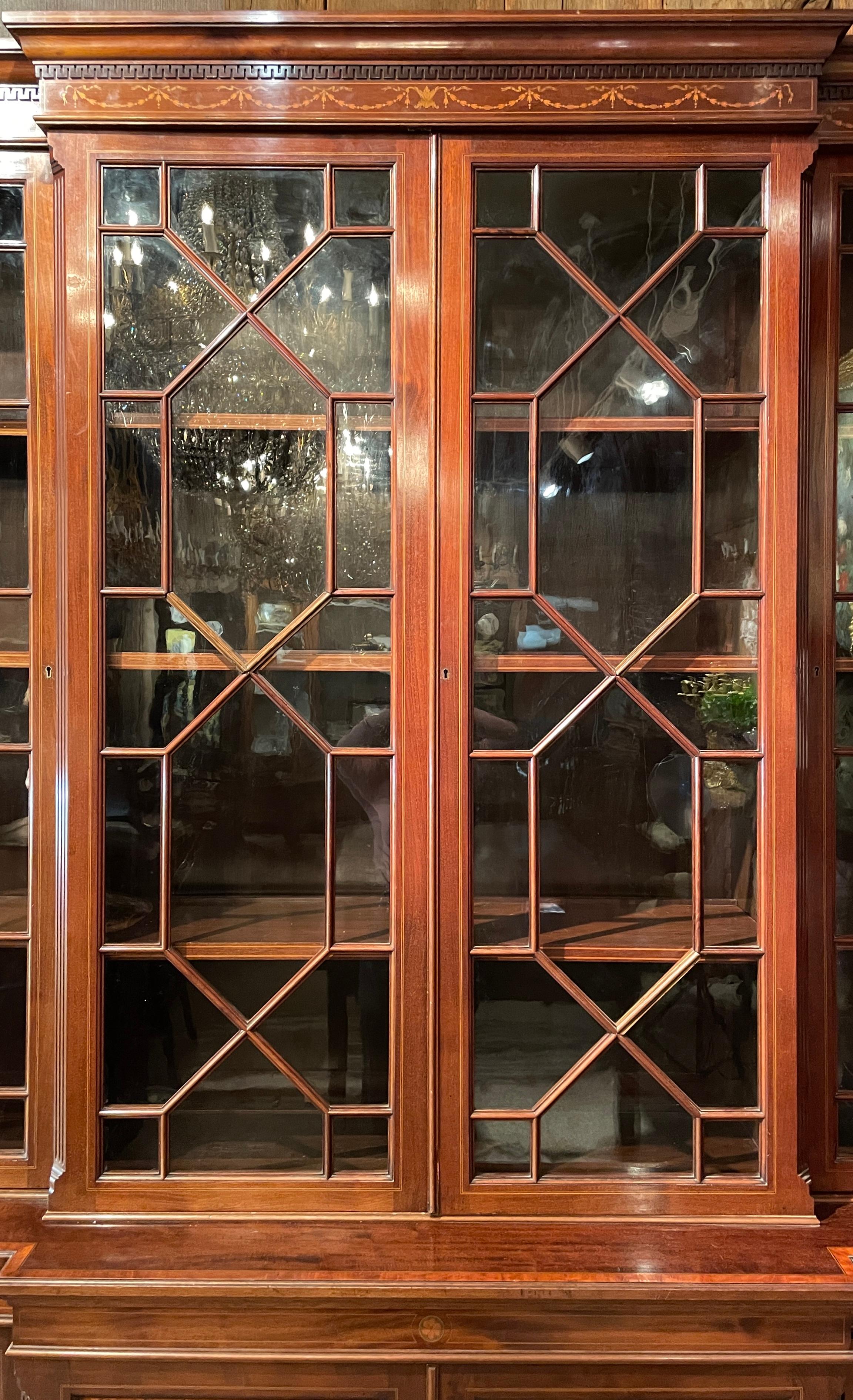 Antique English Mahogany and satinwood Inlaid breakfront bookcase, Circa 1880.