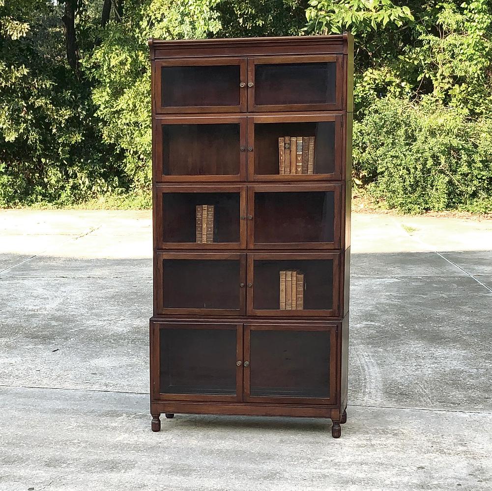 Antique English mahogany bookcase ~ File cabinet is a study in tailored elegance, with the sheer natural beauty of the exotic imported mahogany providing the bulk of the visual appeal. A total of ten glazed doors allow individual access to each