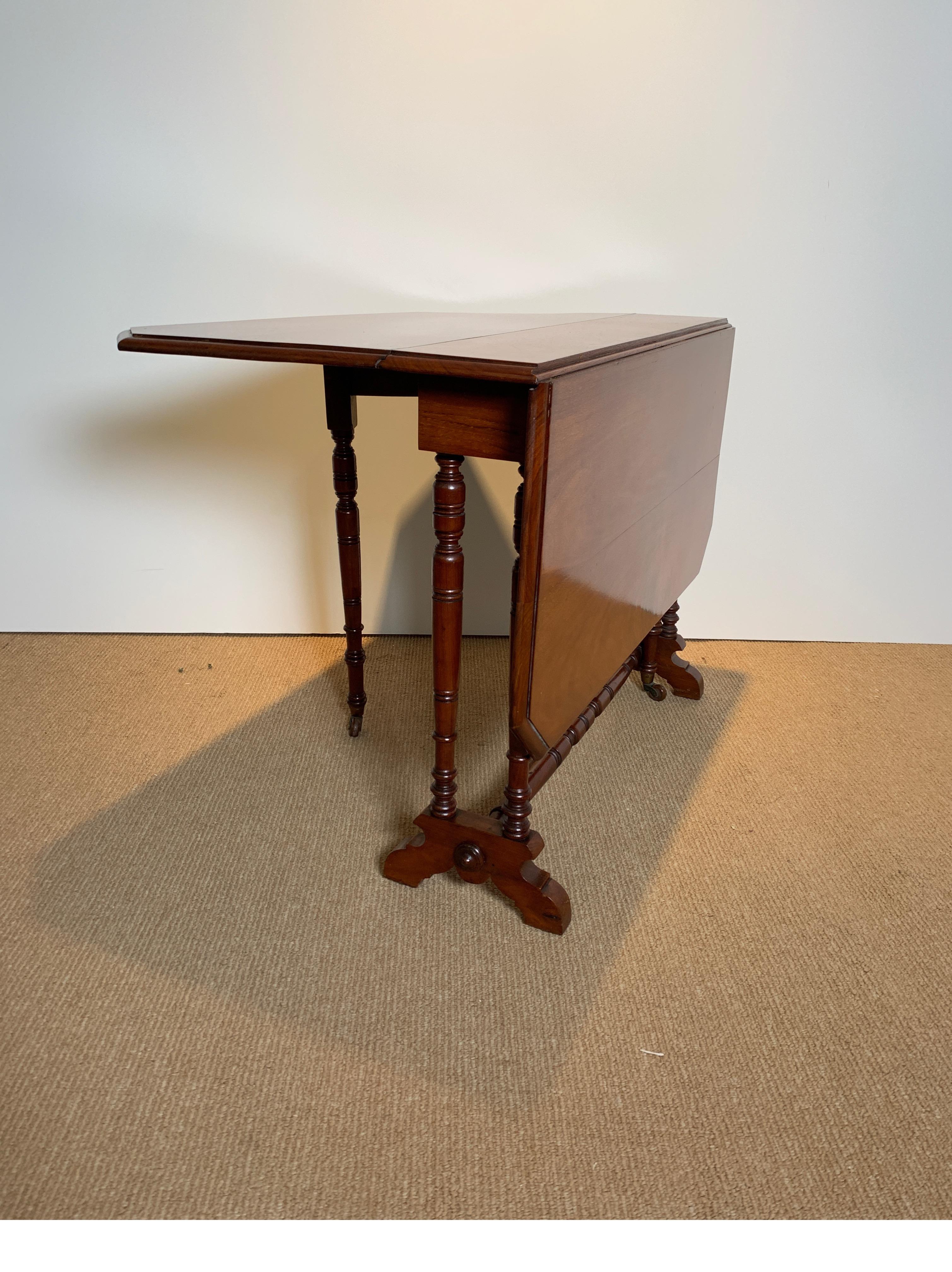 A charming solid mahogany drop-leaf table. England circa 1880. The table with deep leaves which opens fully to 37 inches wide, flods down to only 7 inches. A perfect working table that can be tucked away as a narrow side table. The legs are