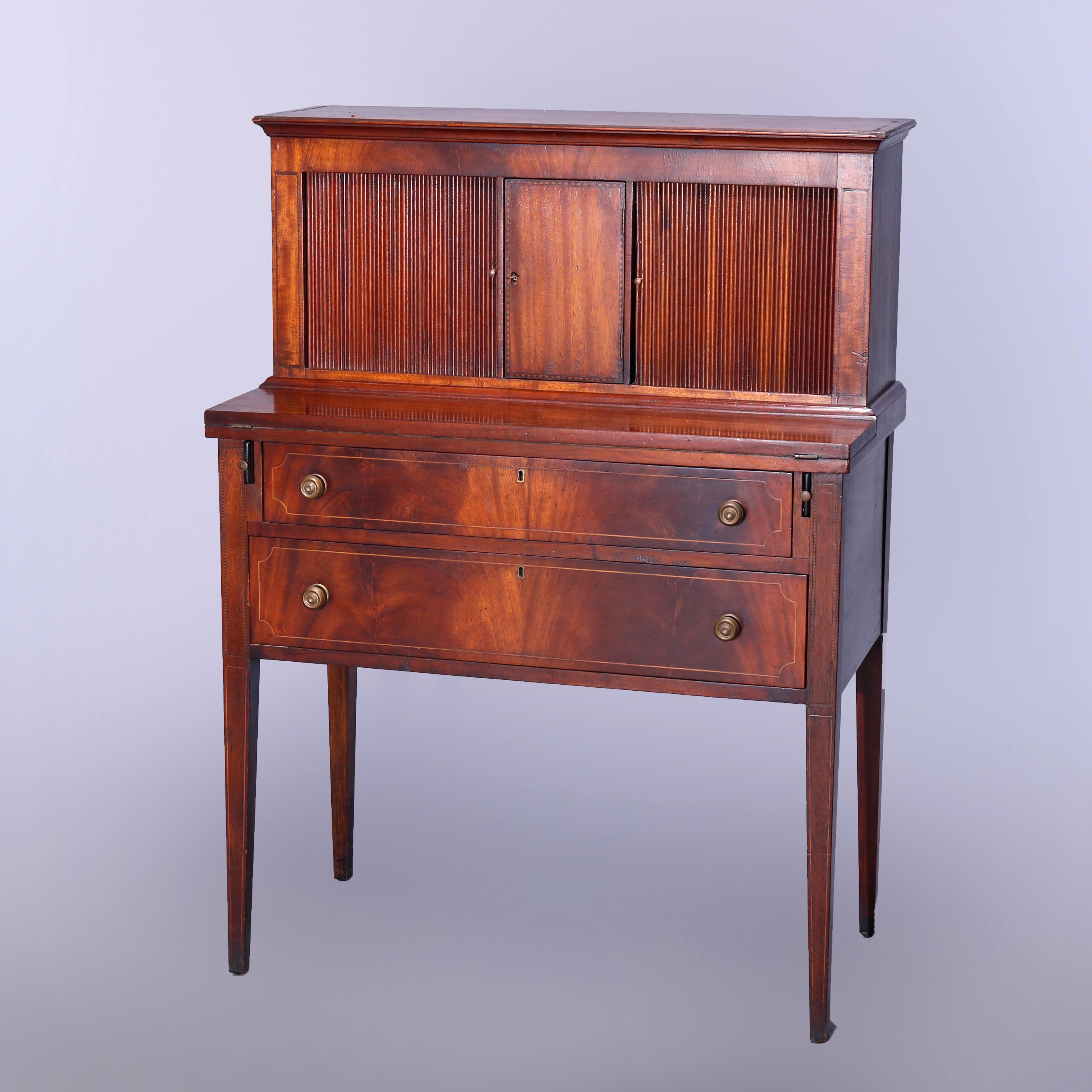 An antique English Hepplewhite secretary offers upper with tambour doors opening to storage compartments over drop down desk opening to writing surface over two long drawers having bookmatched facing, raised on straight and tapered legs, satinwood