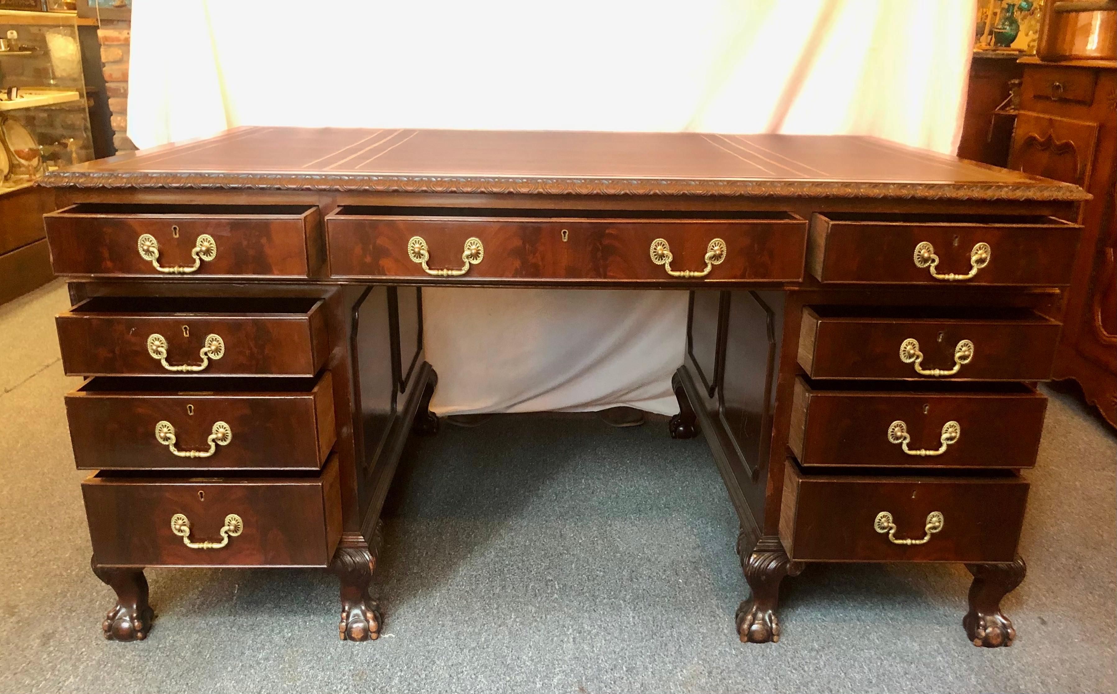 Antique English mahogany partner's desk Chippendale design Circa 1900-1920. Original hardware and new leather.