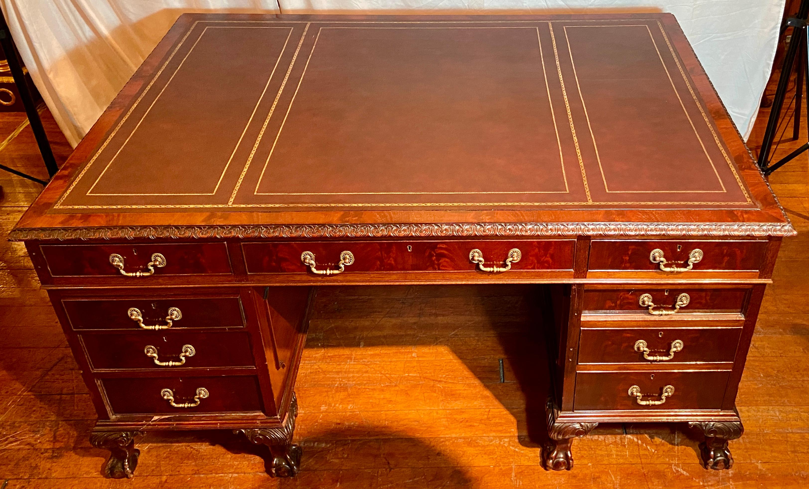 Antique English mahogany partner's desk with gadroon border and new leather, circa 1890-1920.