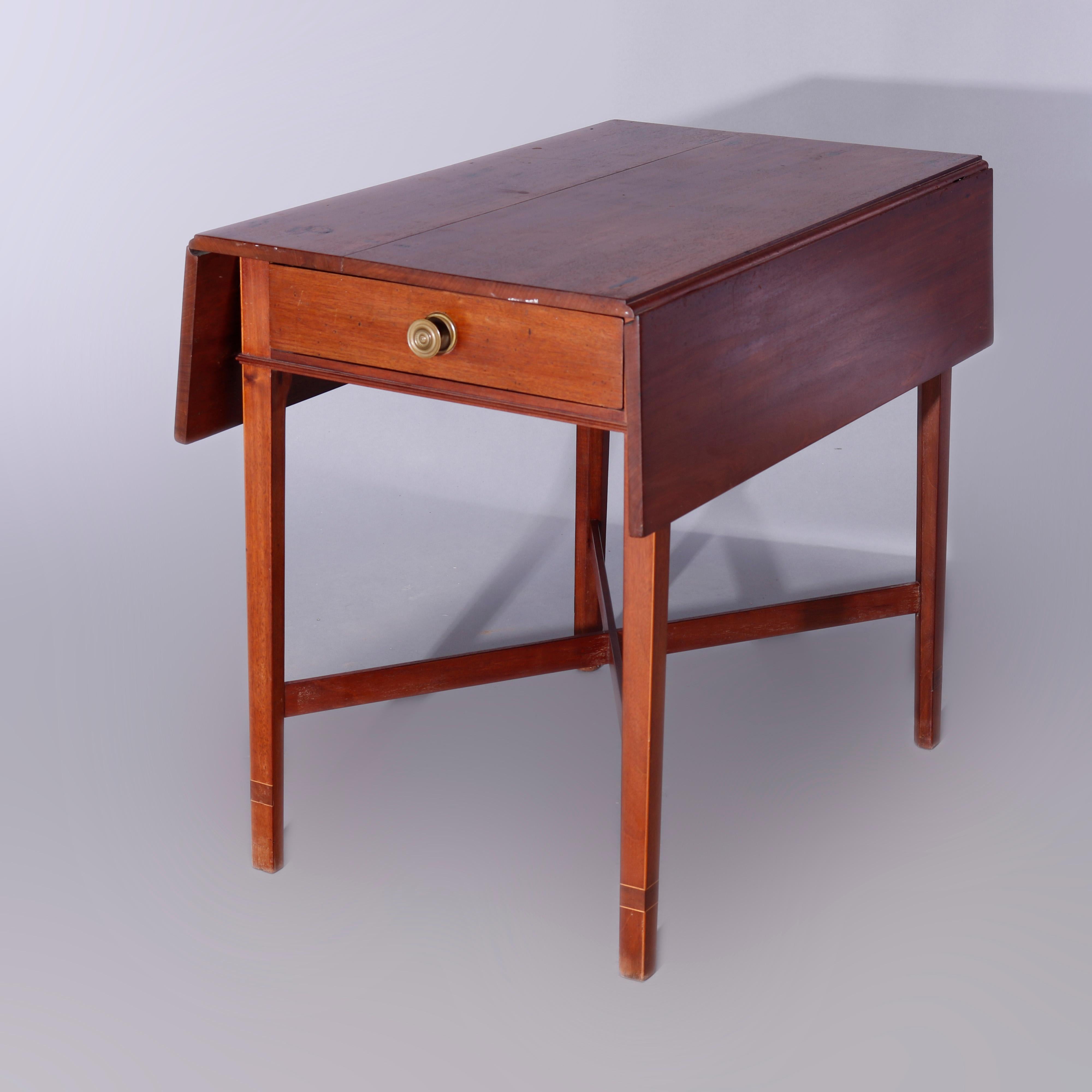 An antique English pembroke table offers mahogany construction with top having drop-leaves over single drawer case, raised on square and tapered legs having x-form stretcher, c1820

Measures - 27.25'' H x 31.5'' W x 19.5'' D.

Catalogue Note: Ask