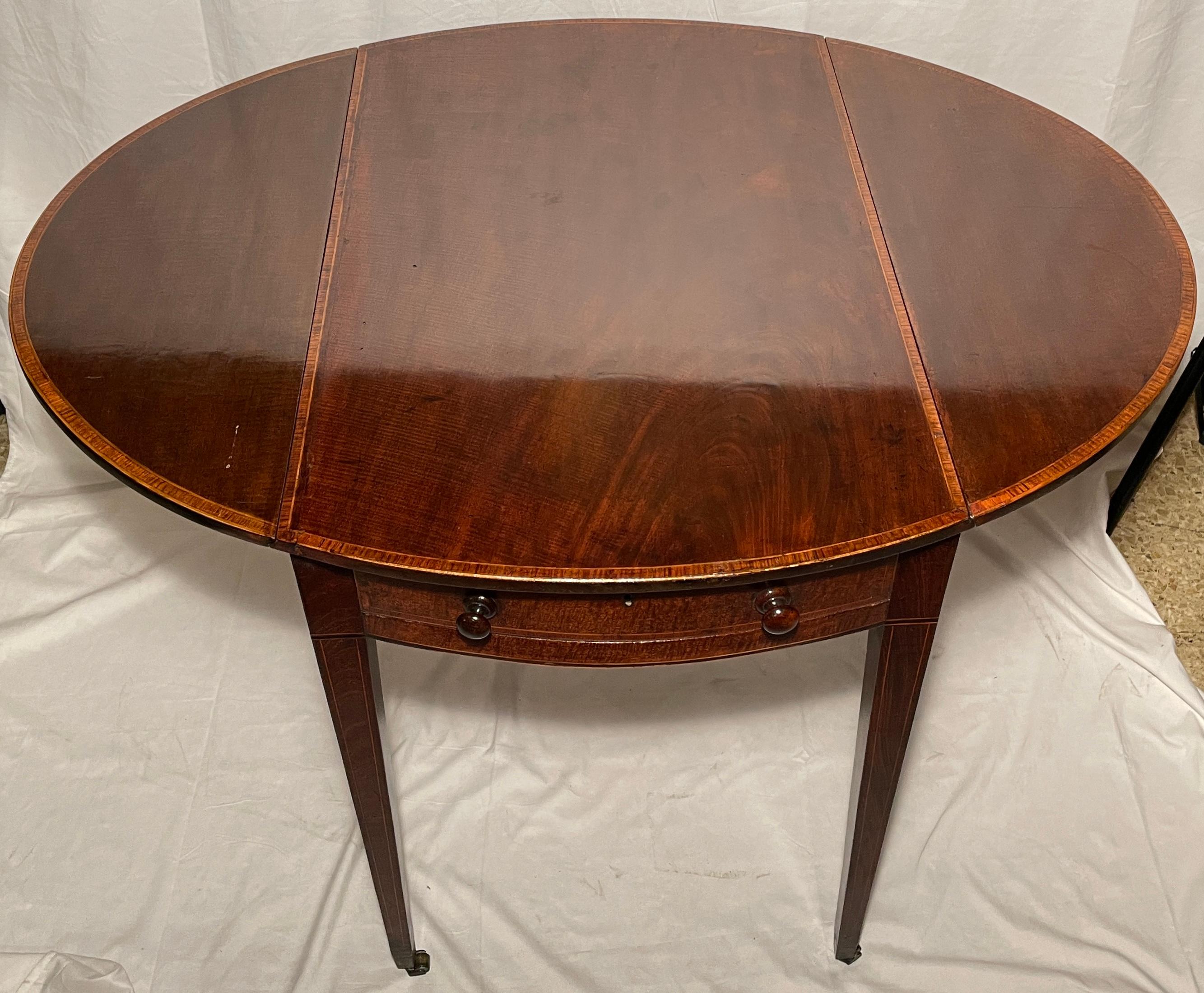 Antique English mahogany Pembroke table, circa 1860. 
Measurements:
28 inches high 
38 inches wide (open)
19.75 inches wide (closed)
30 inches deep. 