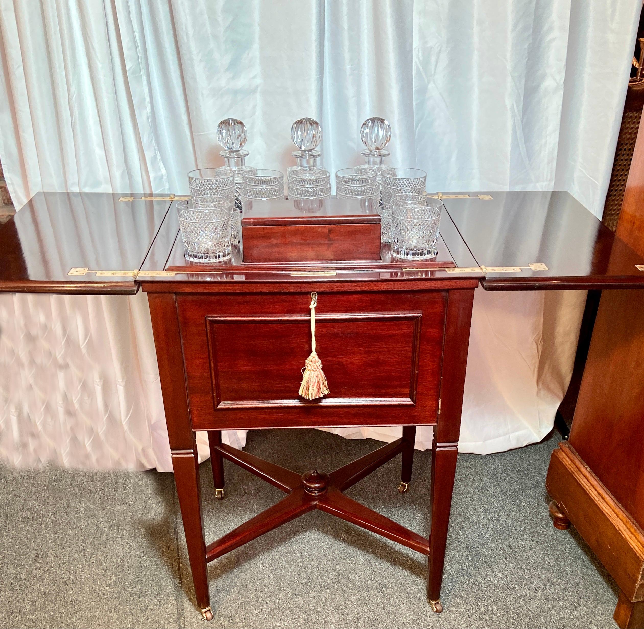 Antique English mahogany pop-up bar on caster feet with original fitted interior of crystal barware (Included), Circa 1890's.