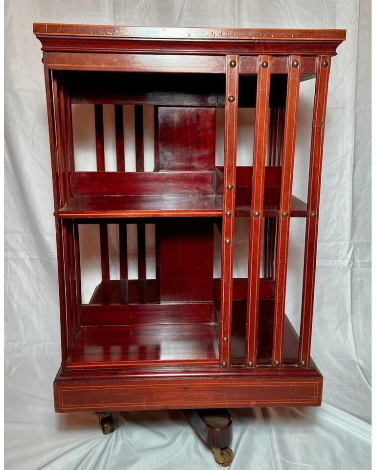 Antique english mahogany and satinwood revolving bookcase on casters, Circa 1880-1890.