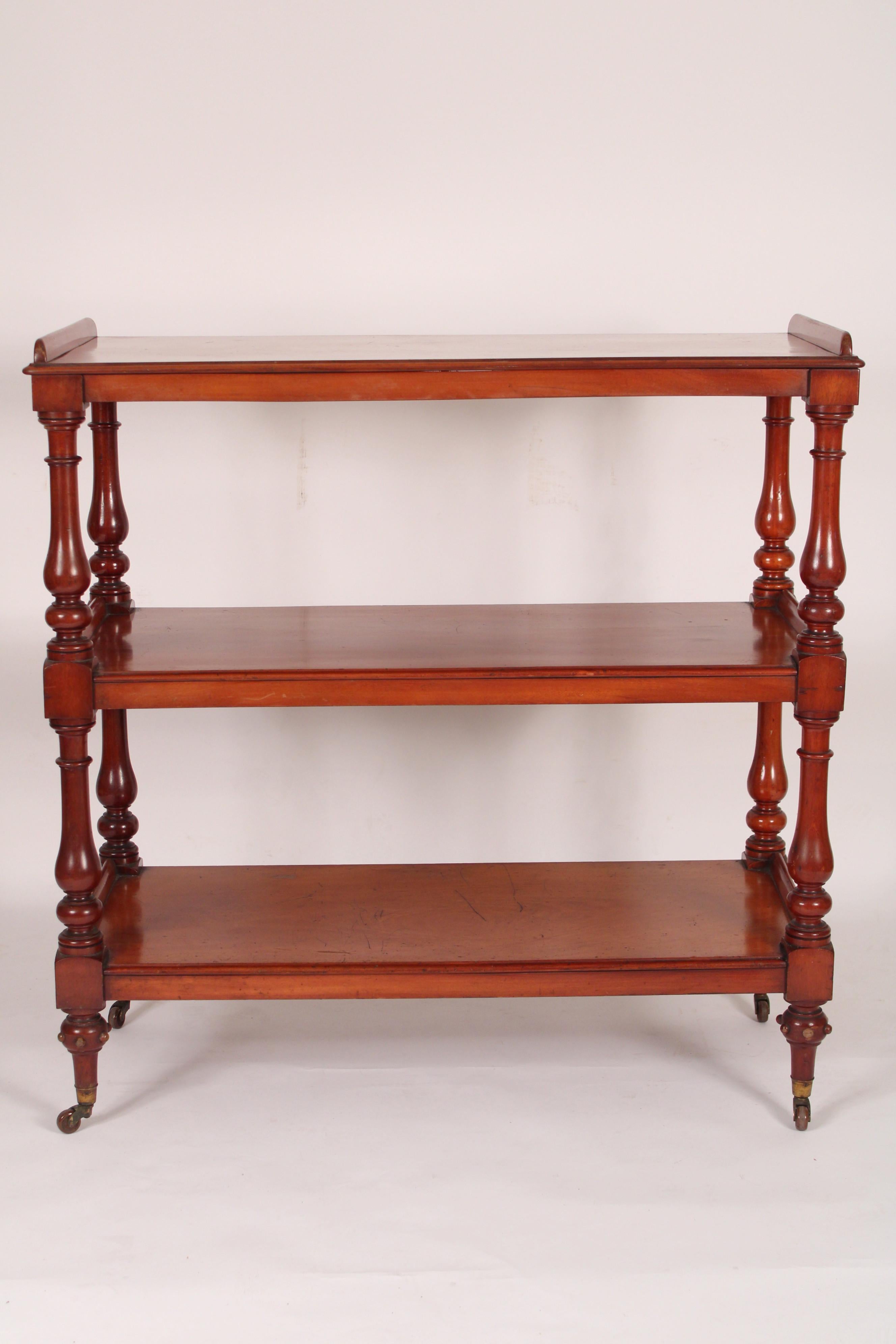 Antique William IV style mahogany 3 tier trolley / etagere, on brass wheels, late 19th century. The brass feet are stamped W. Hopkins & Son, Birmingham.
