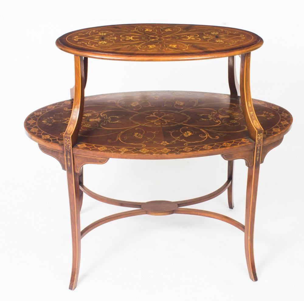 This is a truly exceptional antique English late Victorian mahogany and satinwood marquetry oval two tier 'etagere', in the manner of Edwards & Roberts, circa 1890 in date.

Crafted from the best flame mahogany, note the wonderful grain to the