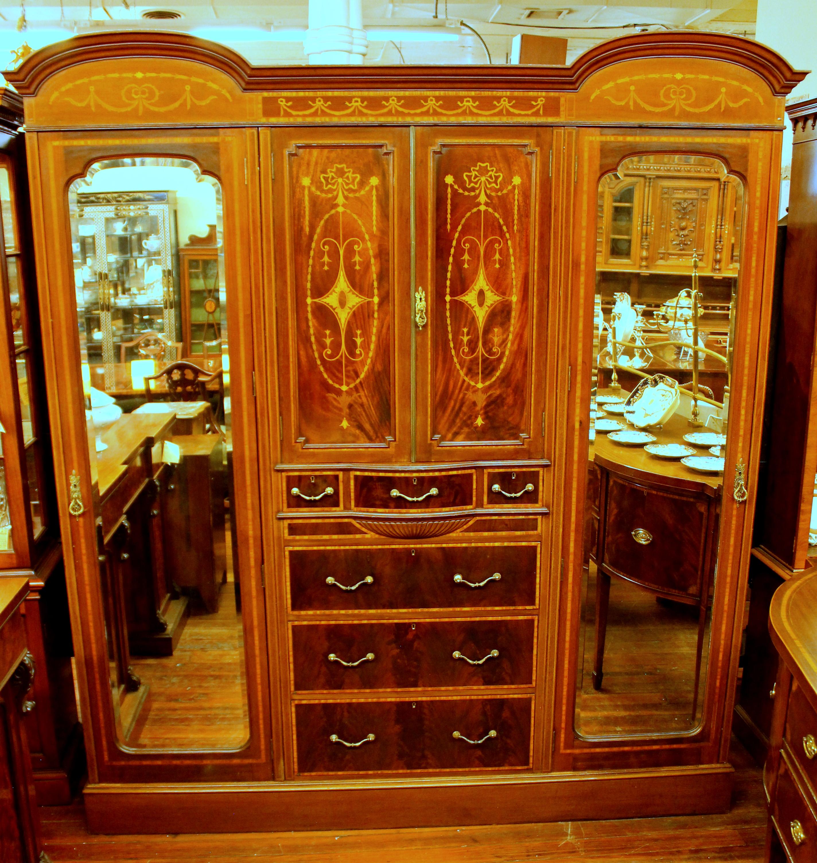 Extraordinary quality antique English marquetry inlaid figured mahogany compactum wardrobe.

Drawers are cedar-lined.

Please note exceptional marquetry inlay and flame mahogany fronts. Disassembles into five easily transportable pieces (top,