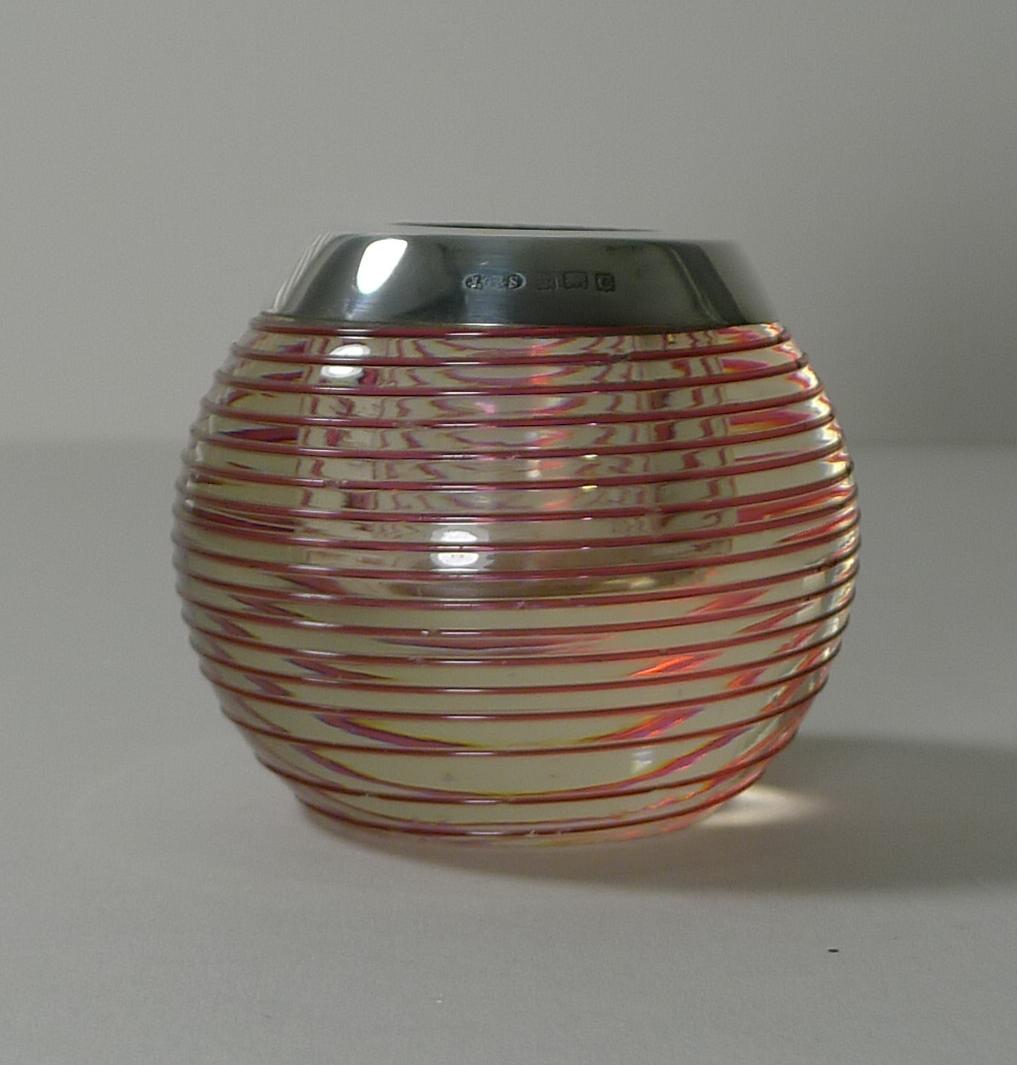 A fabulous Edwardian match striker, clear glass decorated with spun red glass creating an unusual and highly decorative example.

The top is made from sterling silver fully hallmarked for Birmingham 1902 together with the maker's mark for the well