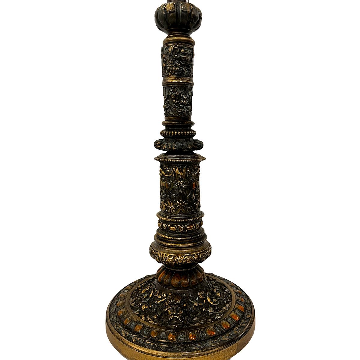 A late 19th century cast metal lamp with heraldic motif on body.

Measurements:
Height of body: 16