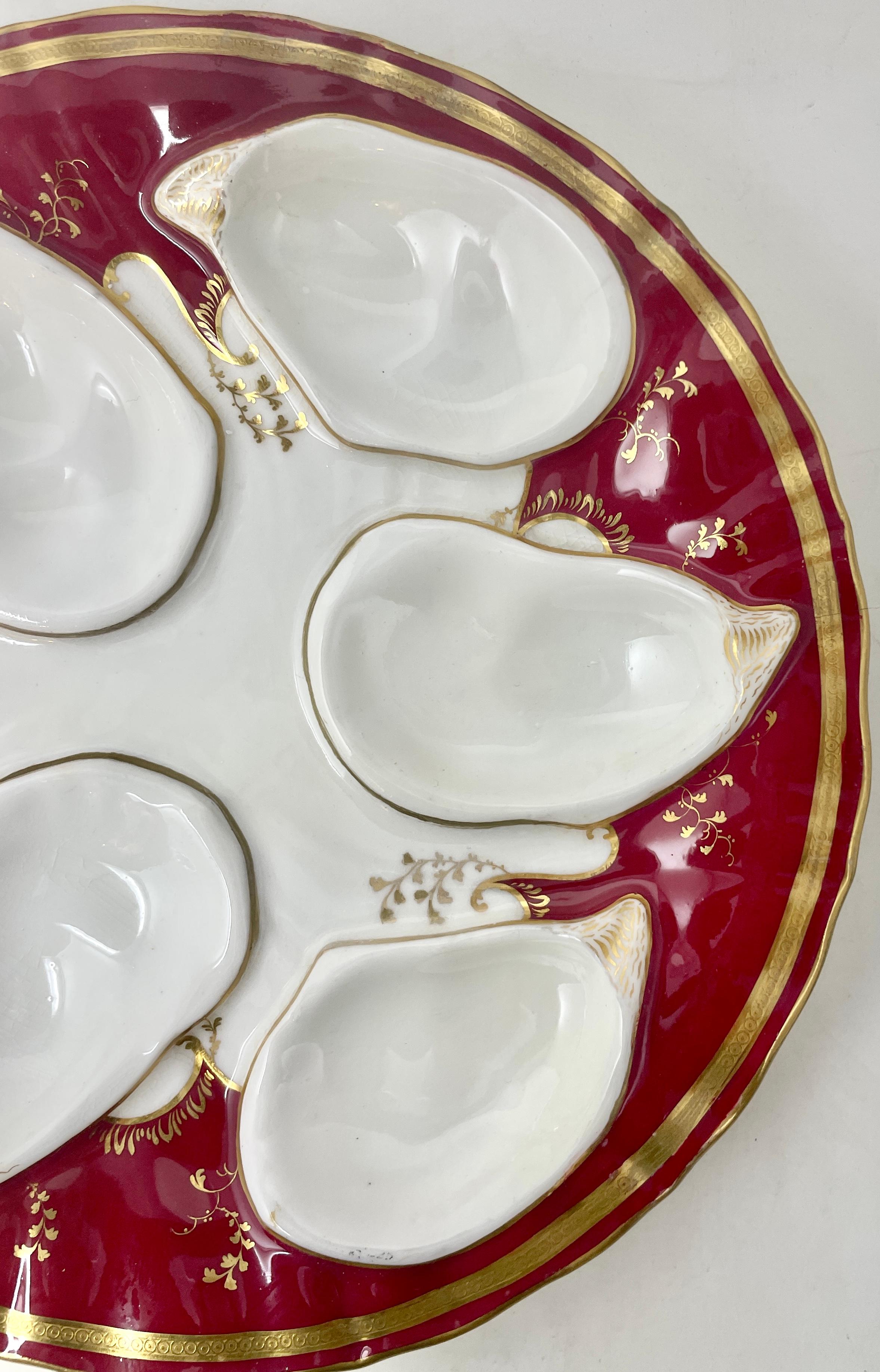 Antique English Minton hand-painted red & gold porcelain oyster plate Made for Davis Collamore & Co. New York, Circa 1900. Beautiful red and ivory background with hand-painted gold embellishments. This is Plate #1 of 2.