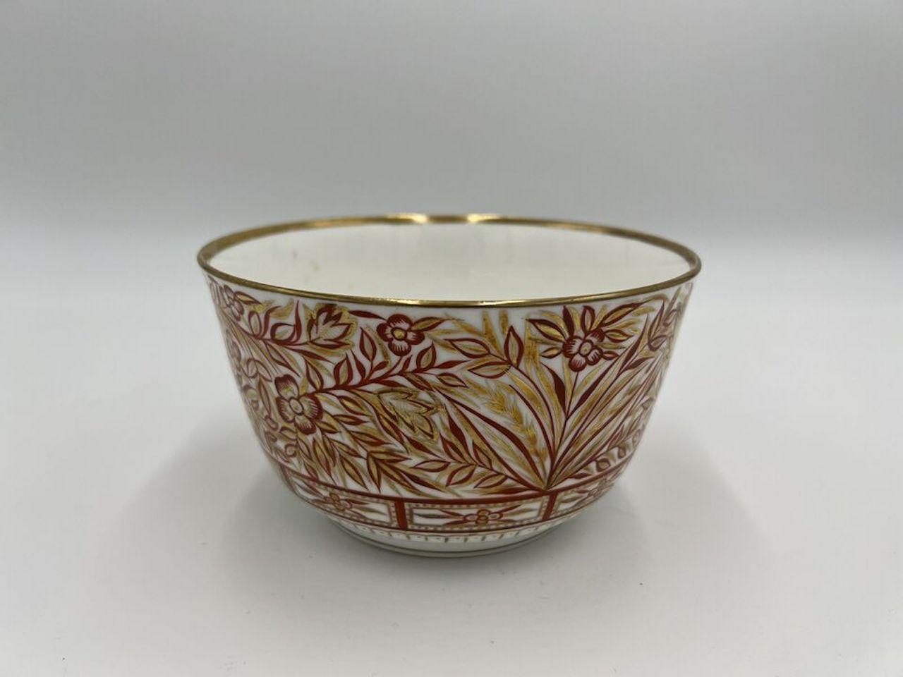 Mintons (English, 1793-2005), circa 1830. A very fine quality antique porcelain waste bowl decorated in a rust ground and heavy gilding. A large pagoda is painted to one side of the bowl and flanked by foliate baskets and vines. A gilt starburst to