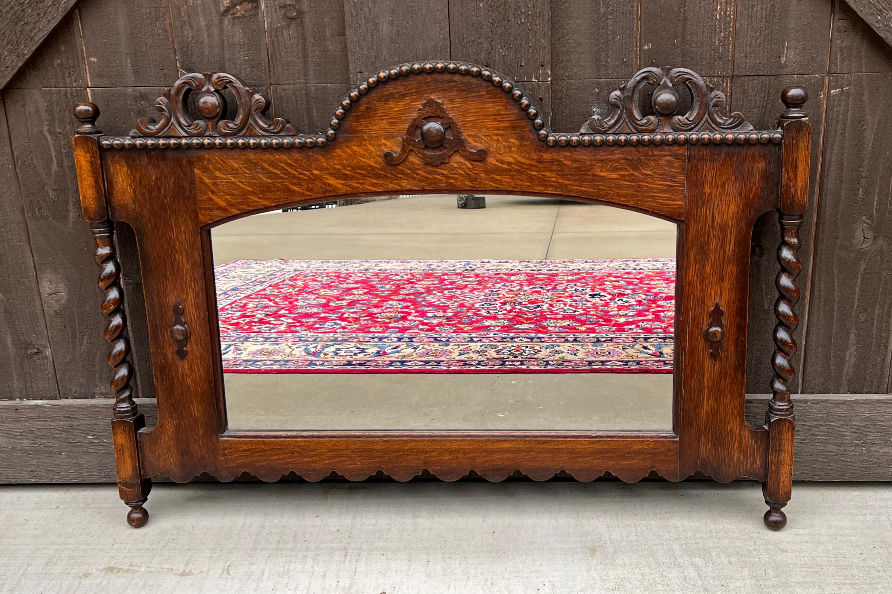 CHARMING Antique English Oak Jacobean Style Rectangular Framed Oak Mirror w/ Barley Twist Posts and Beaded Arched Top~~c. 1930s
 
Popular classic English hanging wall mirror~~beautifully carved with wood back~~perfect for a fireplace mantel, entry