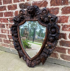 Antique English Mirror Renaissance Revival Oak Frame Shield Shape Lion Wood Back