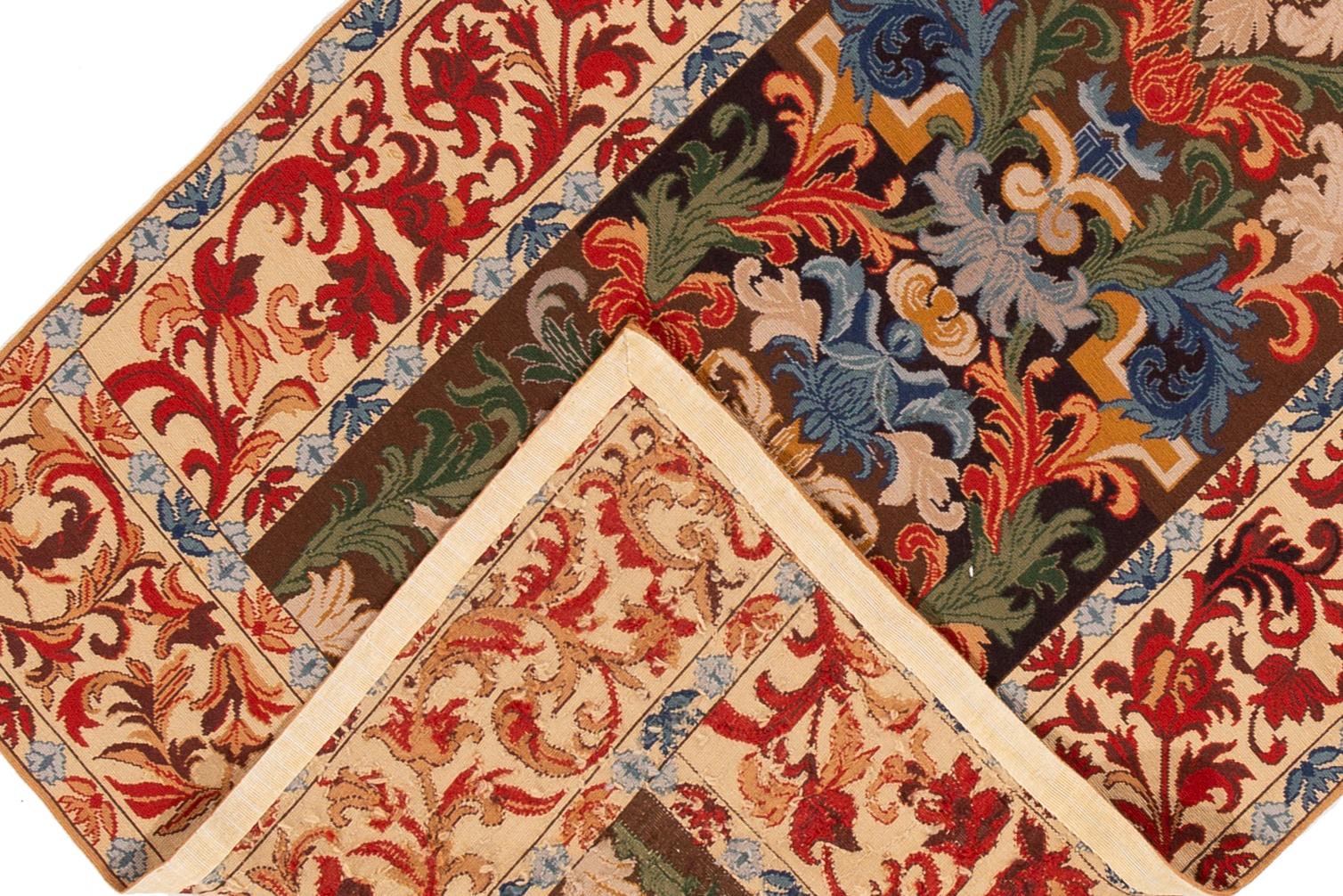 A hand-knotted antique English Needlepoint rug with a floral allover design. This rug measures 4'1