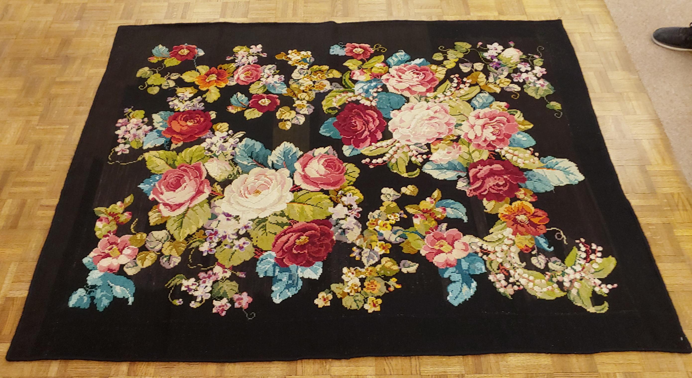 This is a beautiful early English needlepoint done in the traditional Victorian or European motif of bright flowers on a black background, It is 4-6 x 7, circa 1900.