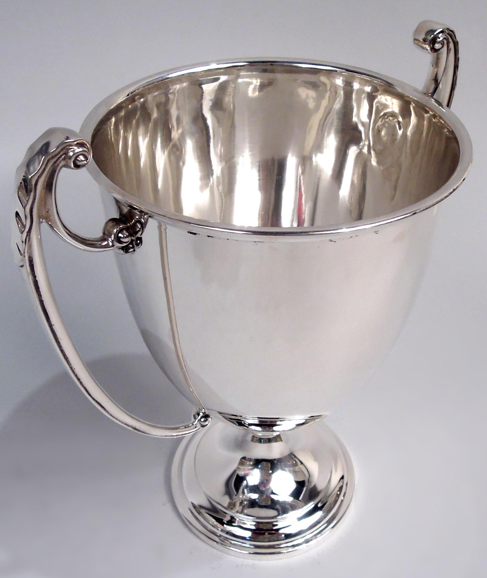 V.I.I.I. en argent massif. Fabriqué par Adie Bros à Birmingham en 1921. Forme néoclassique traditionnelle avec une coupe haute et ovale sur un pied en dôme ; poignées latérales volantes à couvercle en forme de feuille. Beaucoup de place pour la