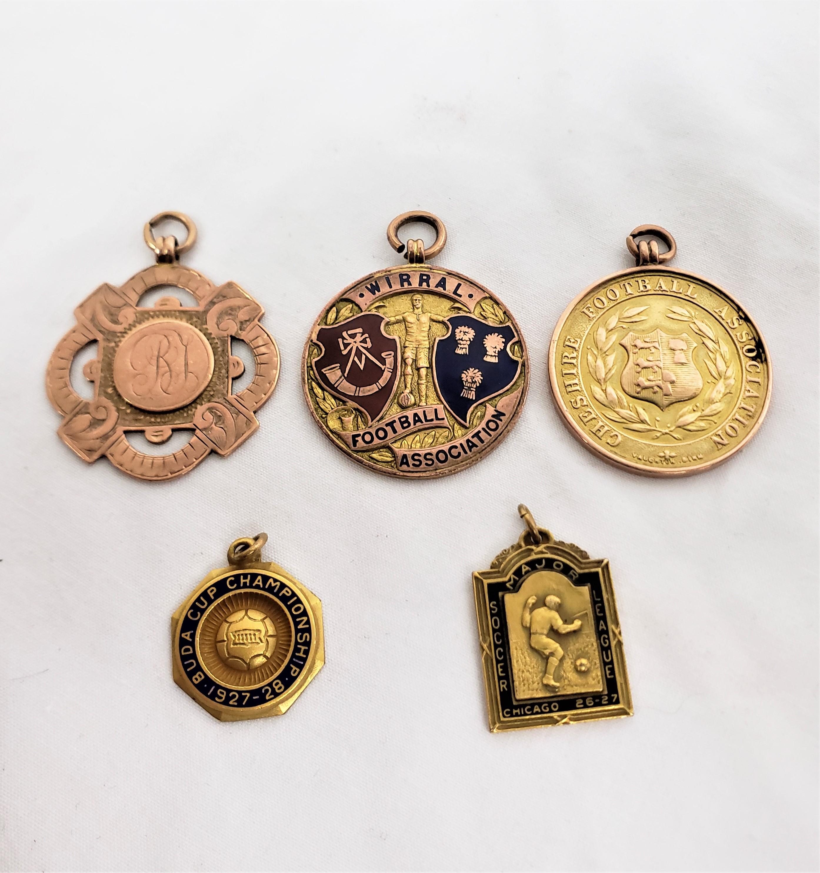 This group of antique English football medals are sugned by an unknown maker, and date to approximately 1914 and done in the period Georgie V style. The three larger medals are each marked for nine karat yellow gold with one being also enamelled,