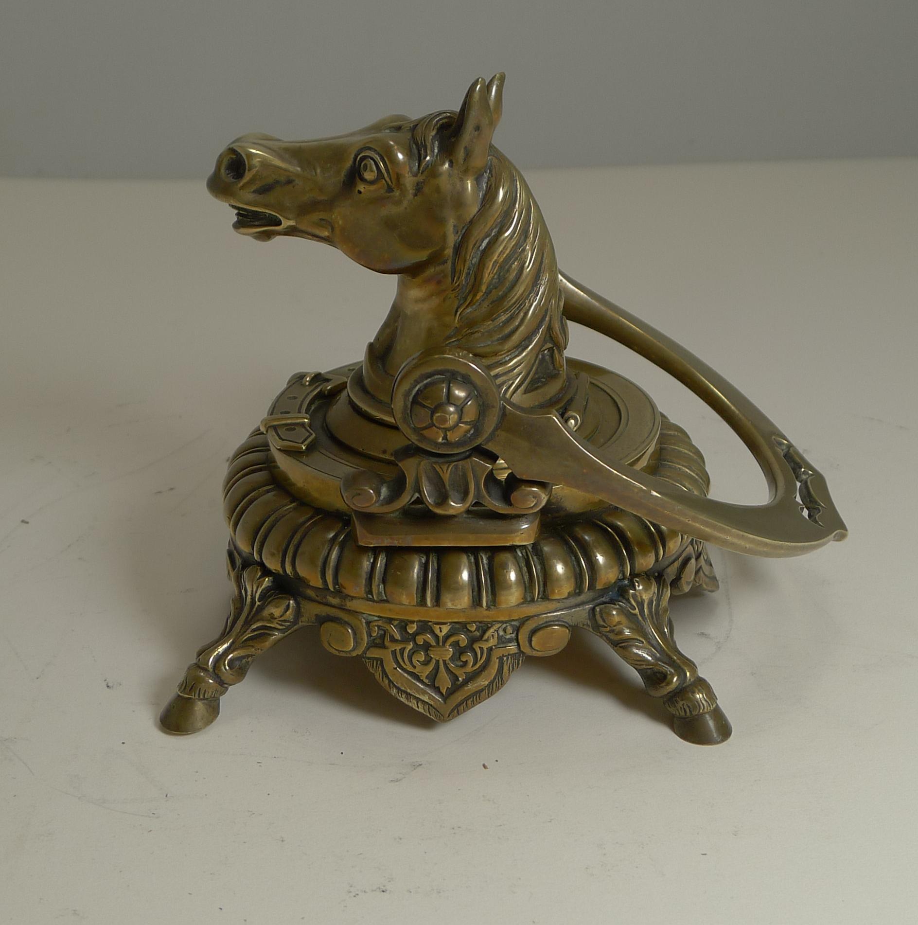 This is only the second time in many years of being in the antiques business that I have come across this wonderful figural equestrian inkwell.

Beautifully cast in solid English brass, the inkwell stands on four horse hoof legs. The folding