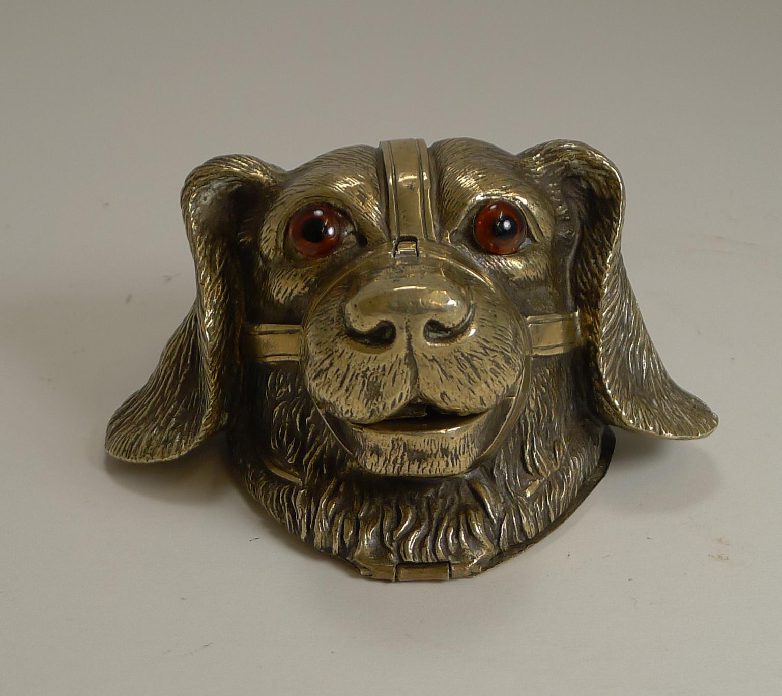 A really charming antique figural inkwell cast in brass with wonderful detail and sporting his two glass eyes.

It's a rather unusual configuration with the nose lifting to reveal the specially shaped glass ink chamber. This is accessed from the