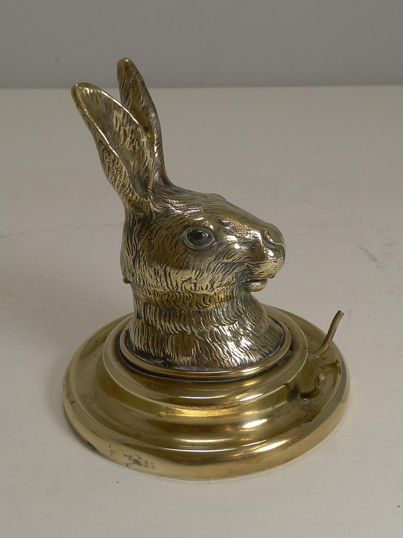 A charming and scarce inkwell made from polished English brass featuring a beautifully cast Hare's head.

At first I thought he sported glass eyes but taking a closer look, they look to be a polished stone carved to create a realistic eye. The