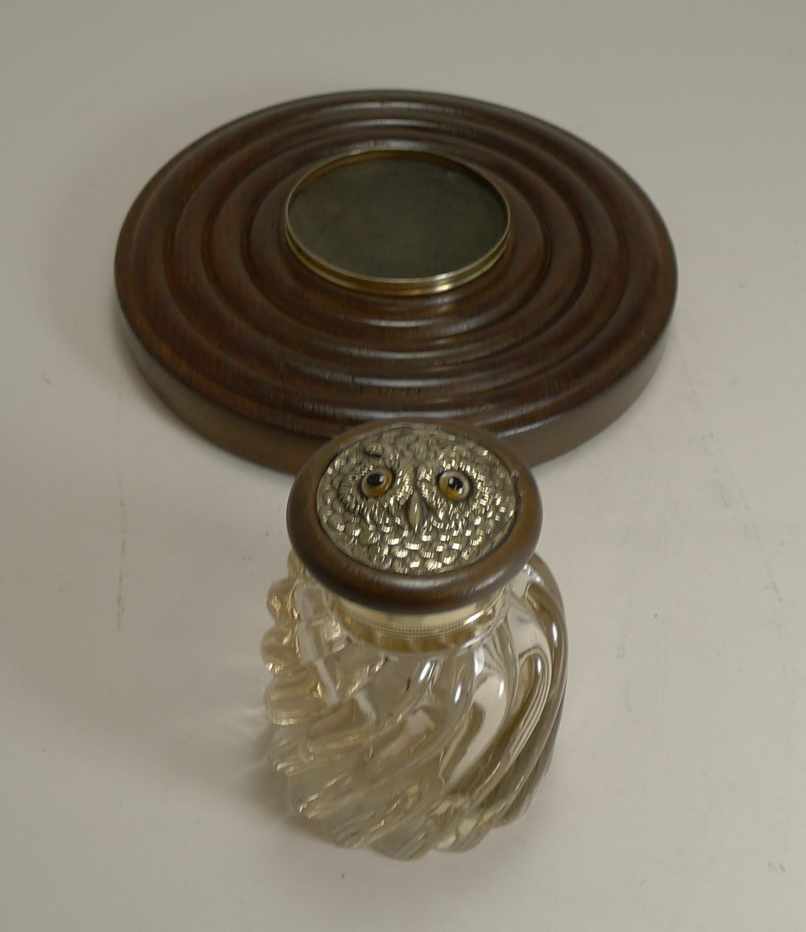 A most unusual and handsome inkstand or inkwell made from a combination of English Oak, glass and brass.

The solid oak base has a polished brass gallery to the top which houses the tactile glass inkwell which has a brass hinged lid, the top inset