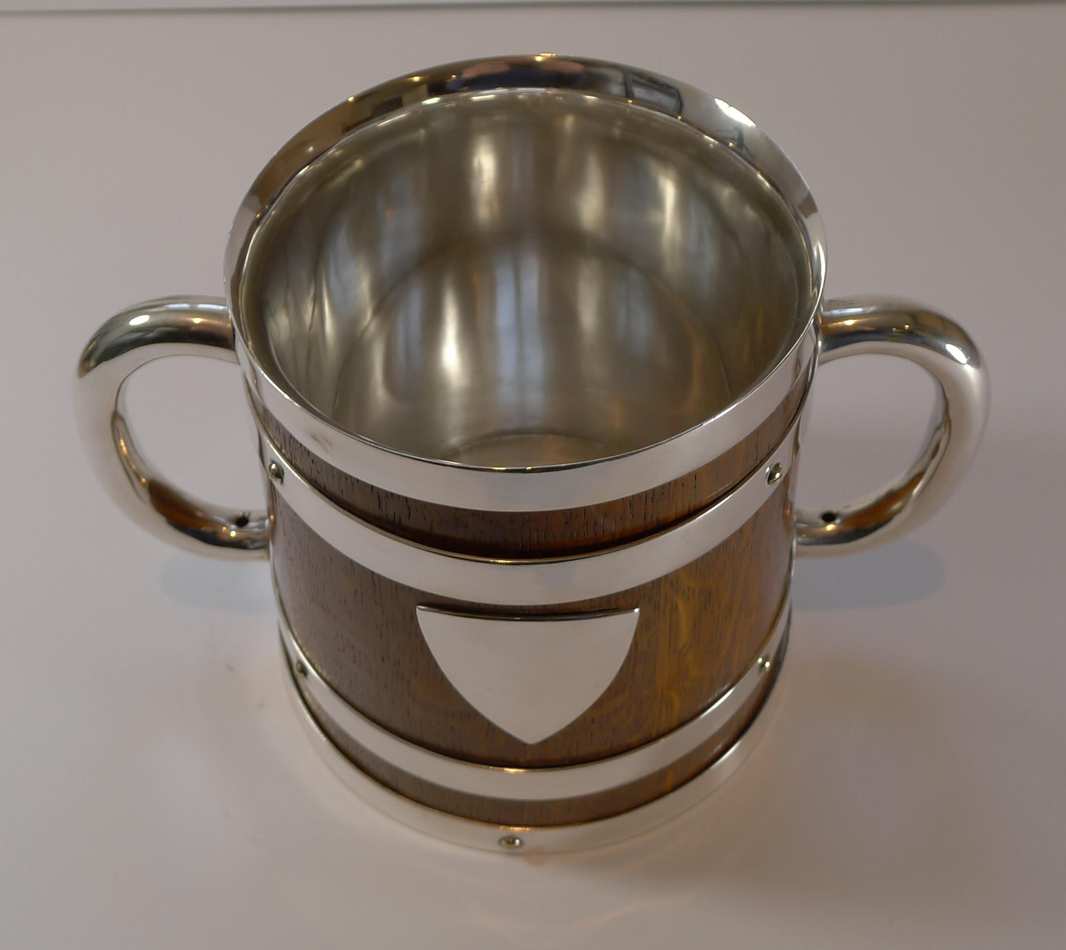 A very handsome late Victorian two-handled loving cup made from solid English Oak with silver plated fittings. The piece is signed by the Birmingham silversmith, Thomas Harwood & Sons, this mark dating the piece to pre-1896, Victorian in