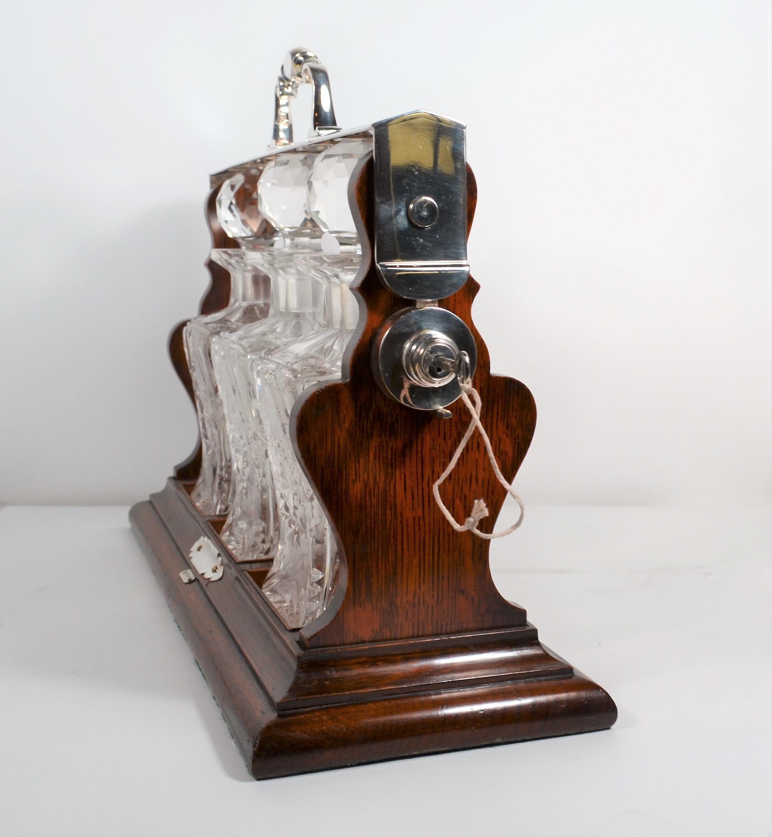 Antique English Oak and Silver Three Bottle Tantalus In Good Condition In New Orleans, LA