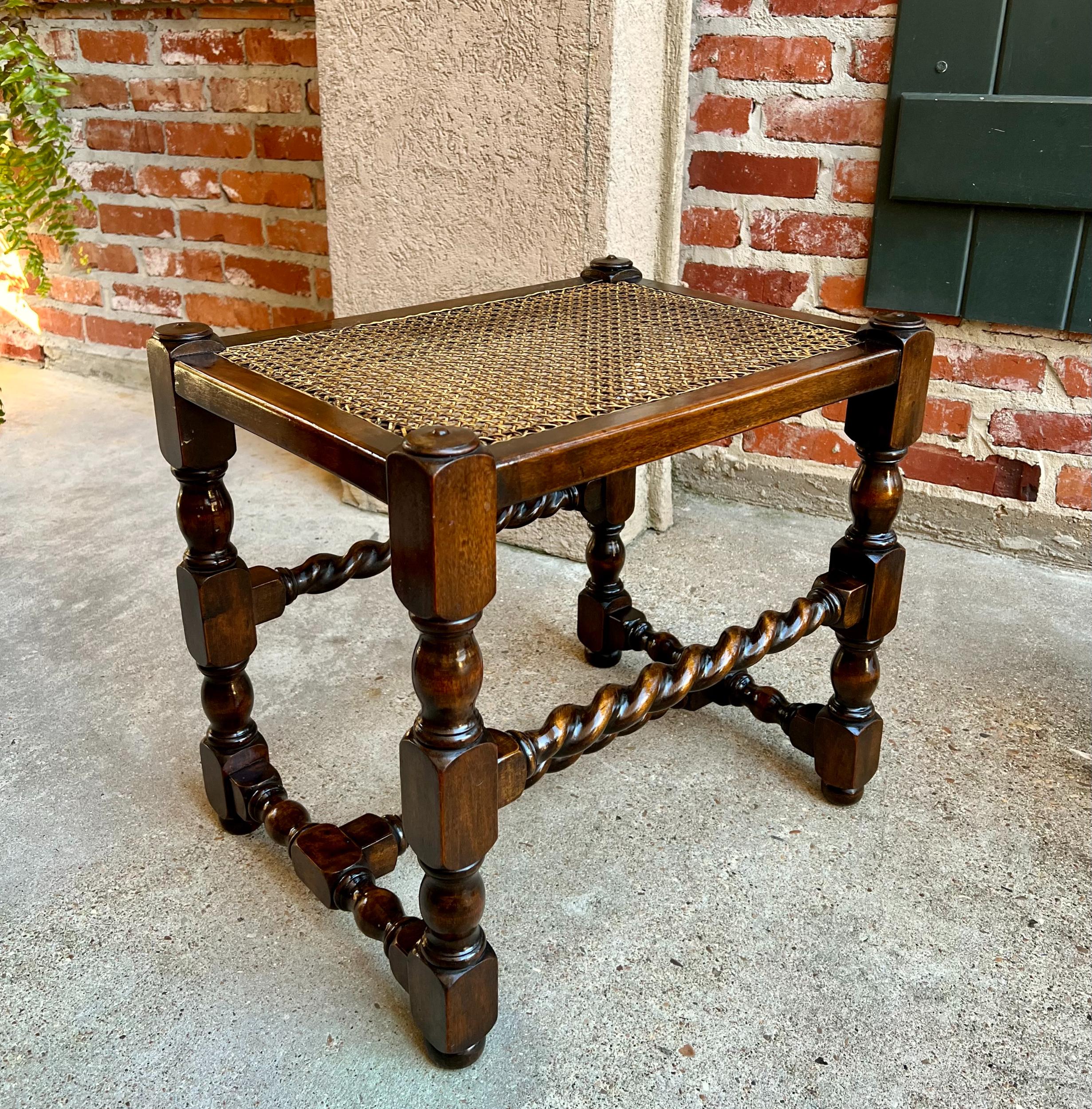Antique English oak barley twist bench stool jacobean w cane top.

Direct from England, a wonderful antique English oak stool or bench.
Hand turned barley twist legs are joined by matching barley twist stretchers to the front and back, with turned