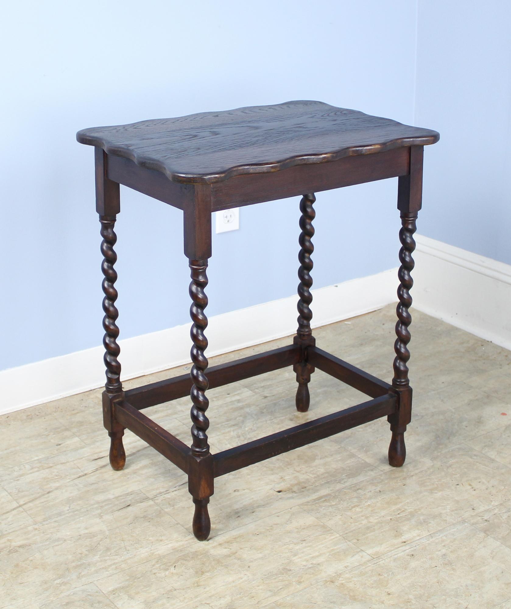 A charming simple occasional table in dark oak with eye-catching barley twist detail. Would make a nice lamp table and would go nicely by the side of a sofa or guest bed.
