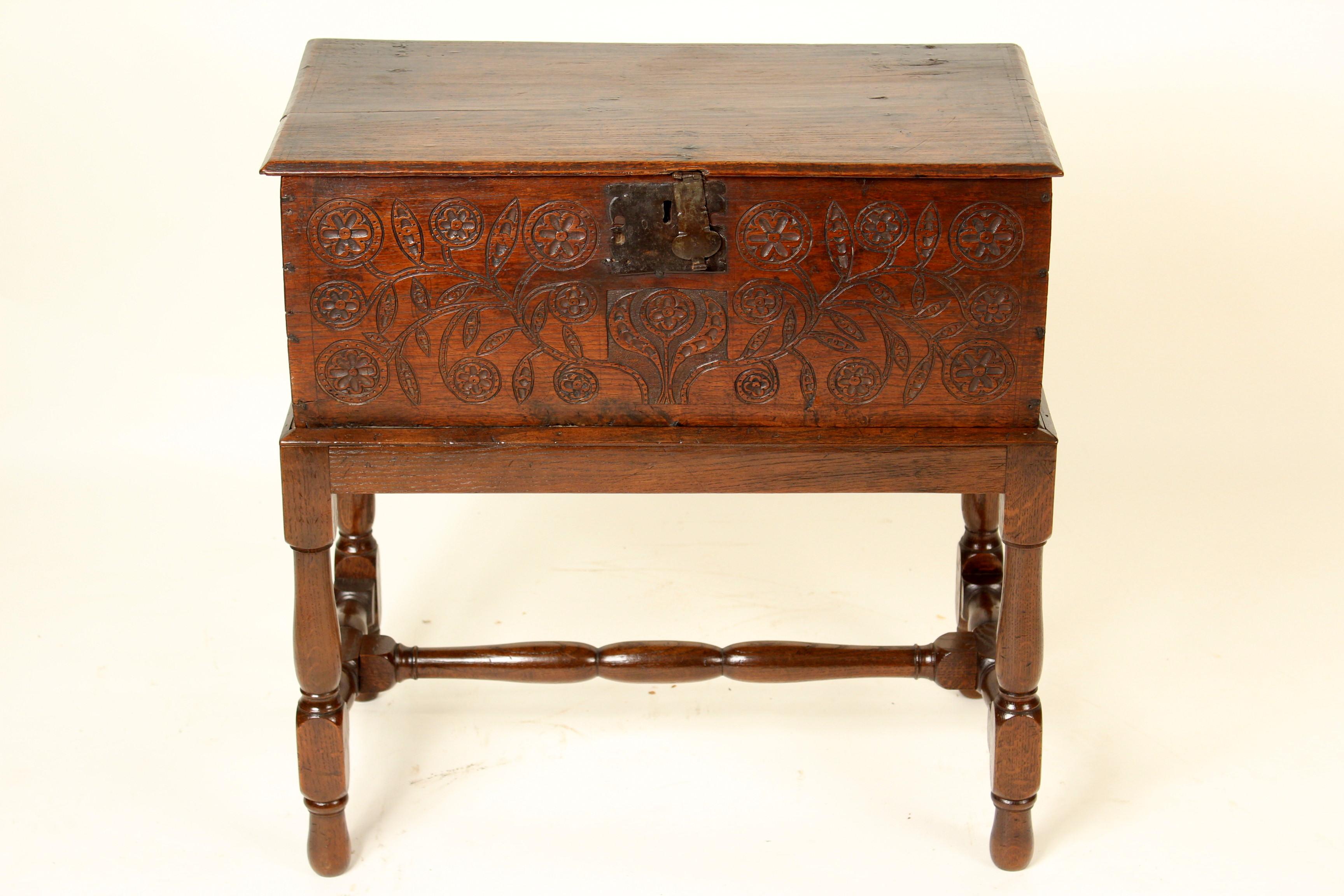 English oak bible box with iron hinges, 19th century resting on a 20th century base. The front carved with flowing vines and Tudor roses. Nice old color. No key.